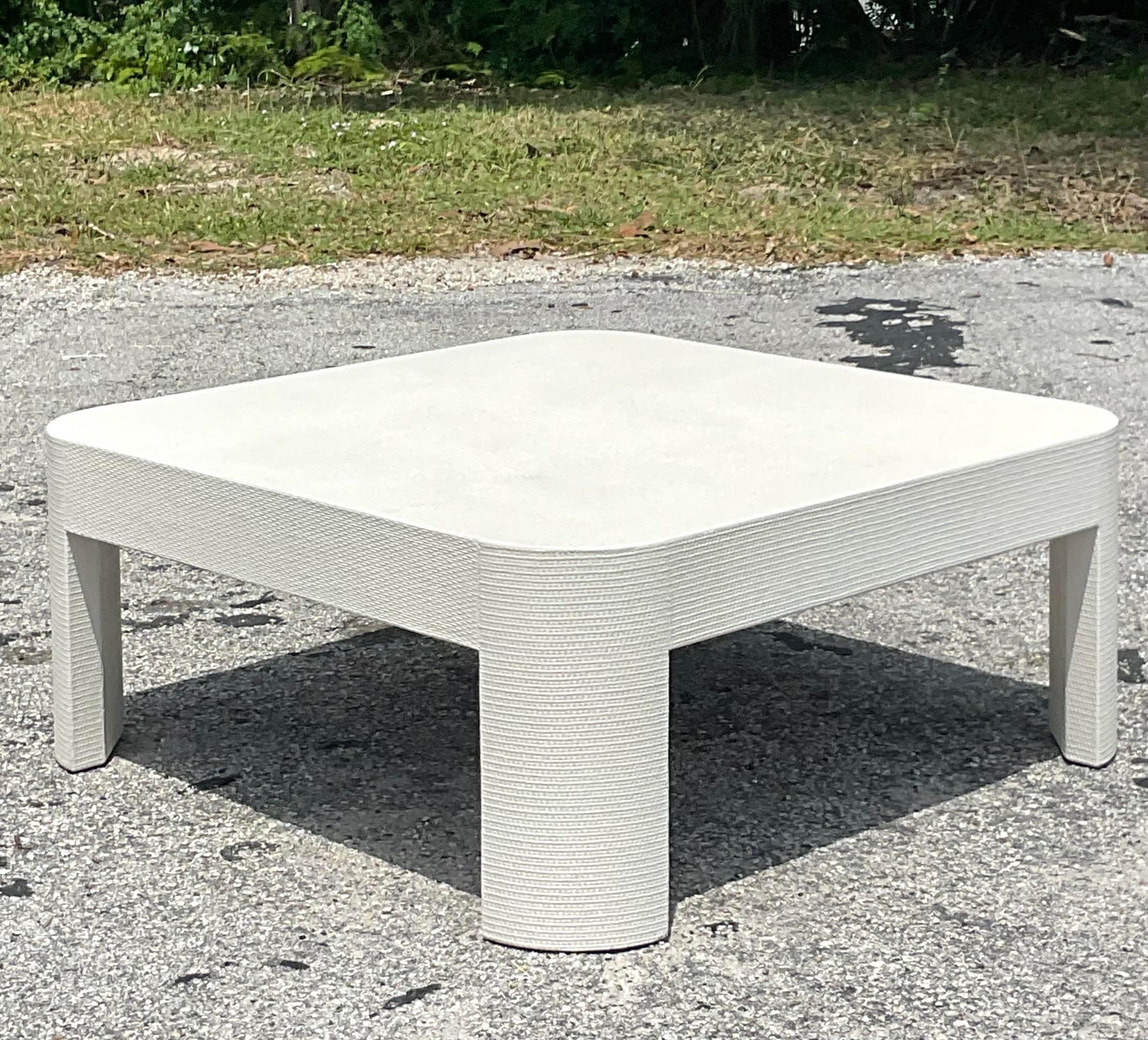 A fabulous vintage Coastal coffee table. A chided wrapped Grasscloth design in a clean modern shape. Acquired from a Palm Beach estate.