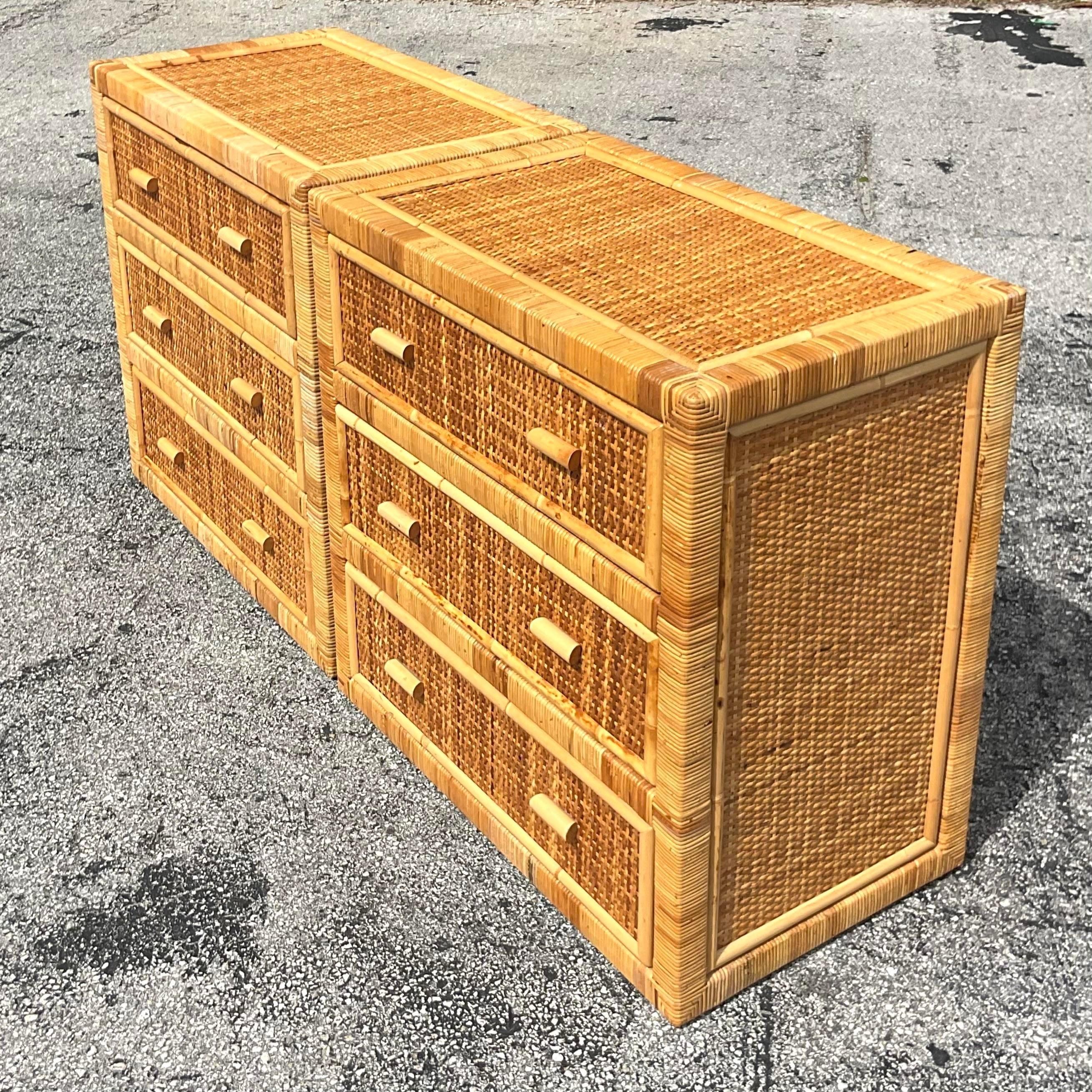 Crafted with timeless elegance, this pair of Vintage Coastal Wrapped Rattan Chests brings a touch of classic Americana to your home decor. Embodying coastal charm and practicality, these drawers exude warmth and style, offering both storage