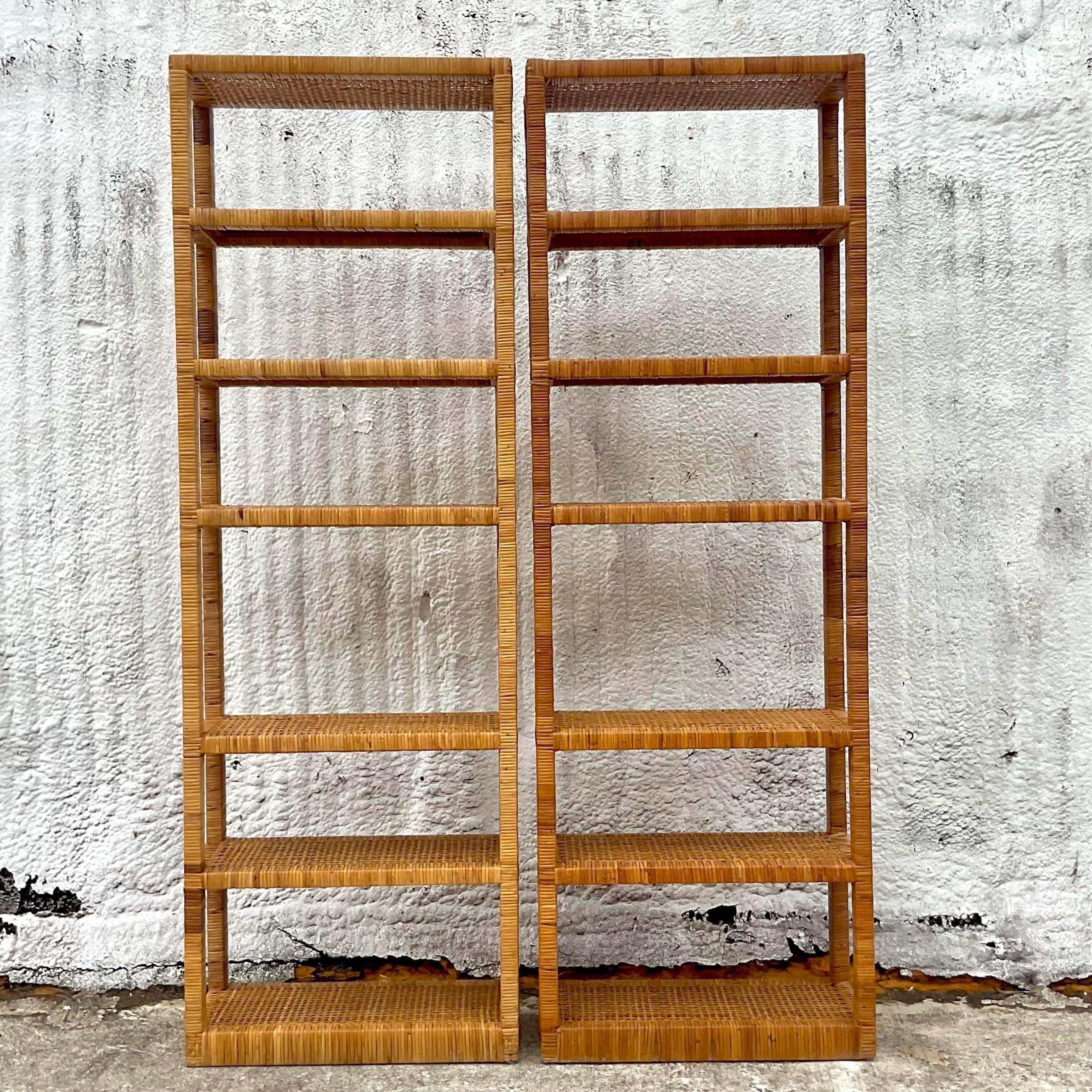 A fabulous pair of vintage Coastal etagere. A chic wrapped rattan frame with a tall and slender profile. Woven rattan shelves. Acquired from a Palm Beach estate.