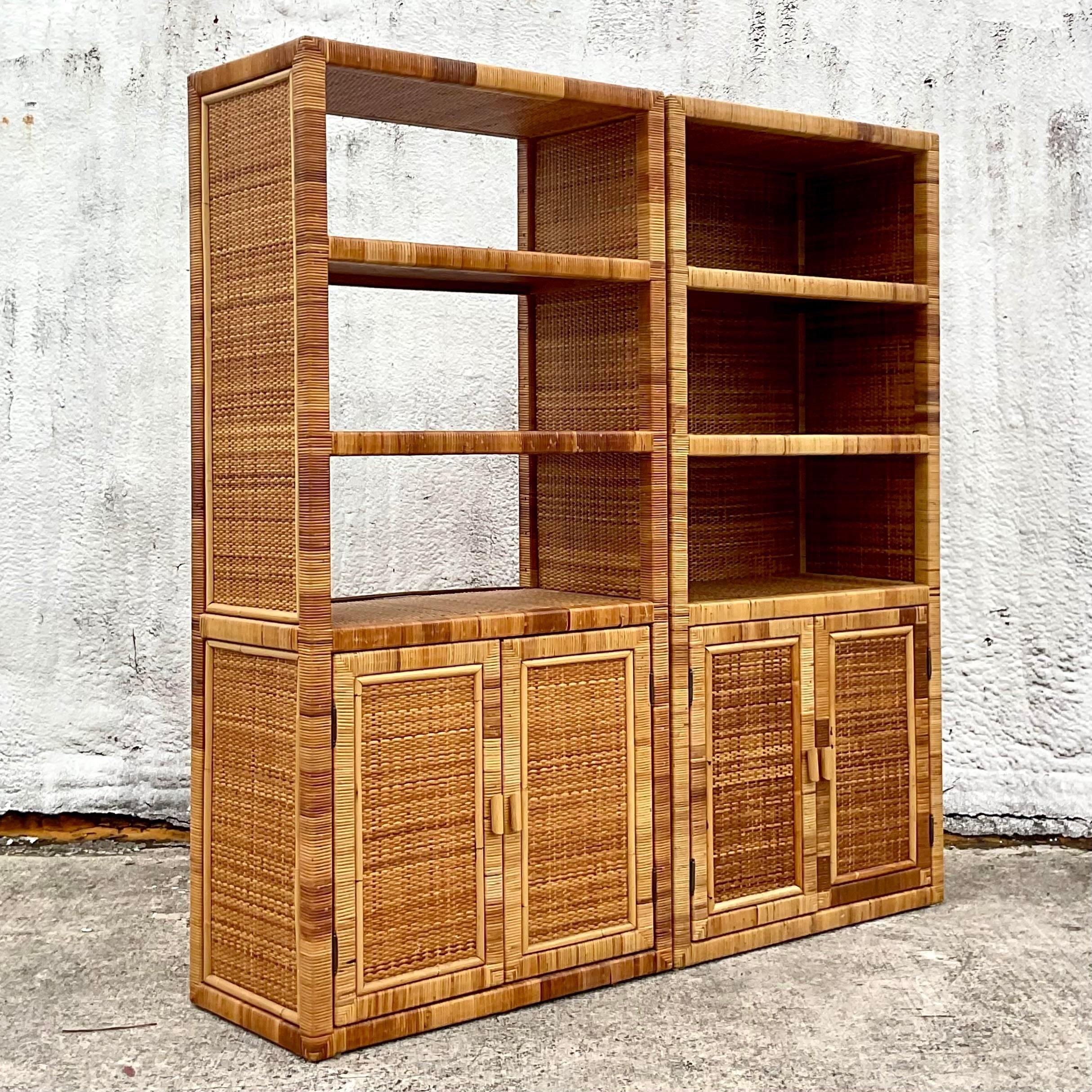A fabulous pair of vintage Coastal etagere. Chic wrapped rattan framed with shelving above and closed storage below. One pack panel has been removed to install video equipment. Acquired from a Palm Beach estate.
