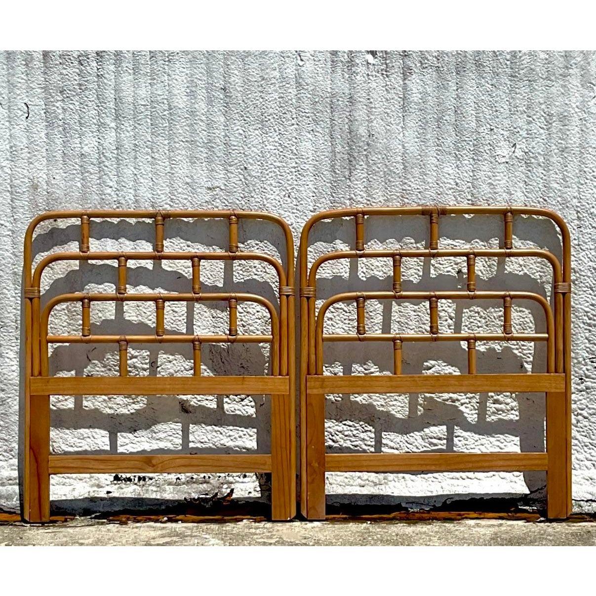 A fabulous pair of vintage Coastal Twin headboards. Chic bent rattan with wrapped rattan joints. Acquired from a Palm Beach estate