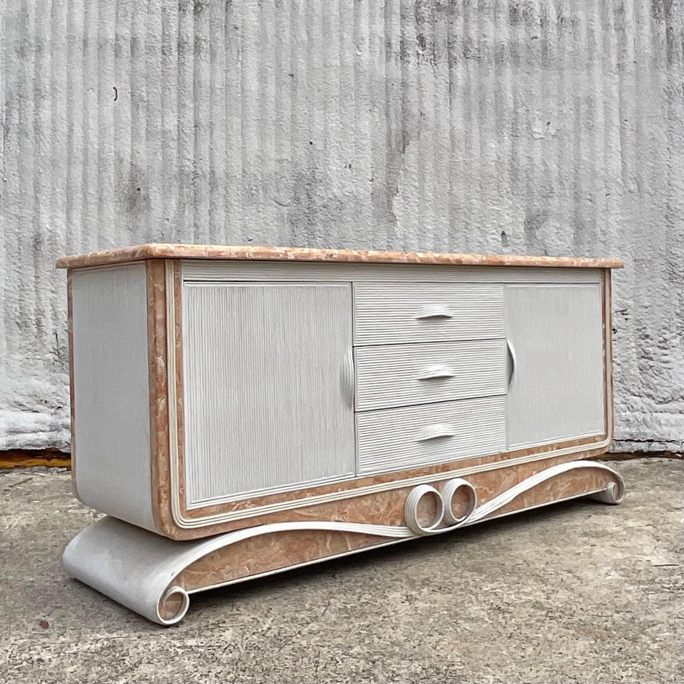 Introducing our Vintage Coastal Reed and tessellated Stone Credenza, a quintessential piece of American craftsmanship. Inspired by the rugged beauty of the coast, this credenza seamlessly combines natural reed and stone elements to evoke a sense of