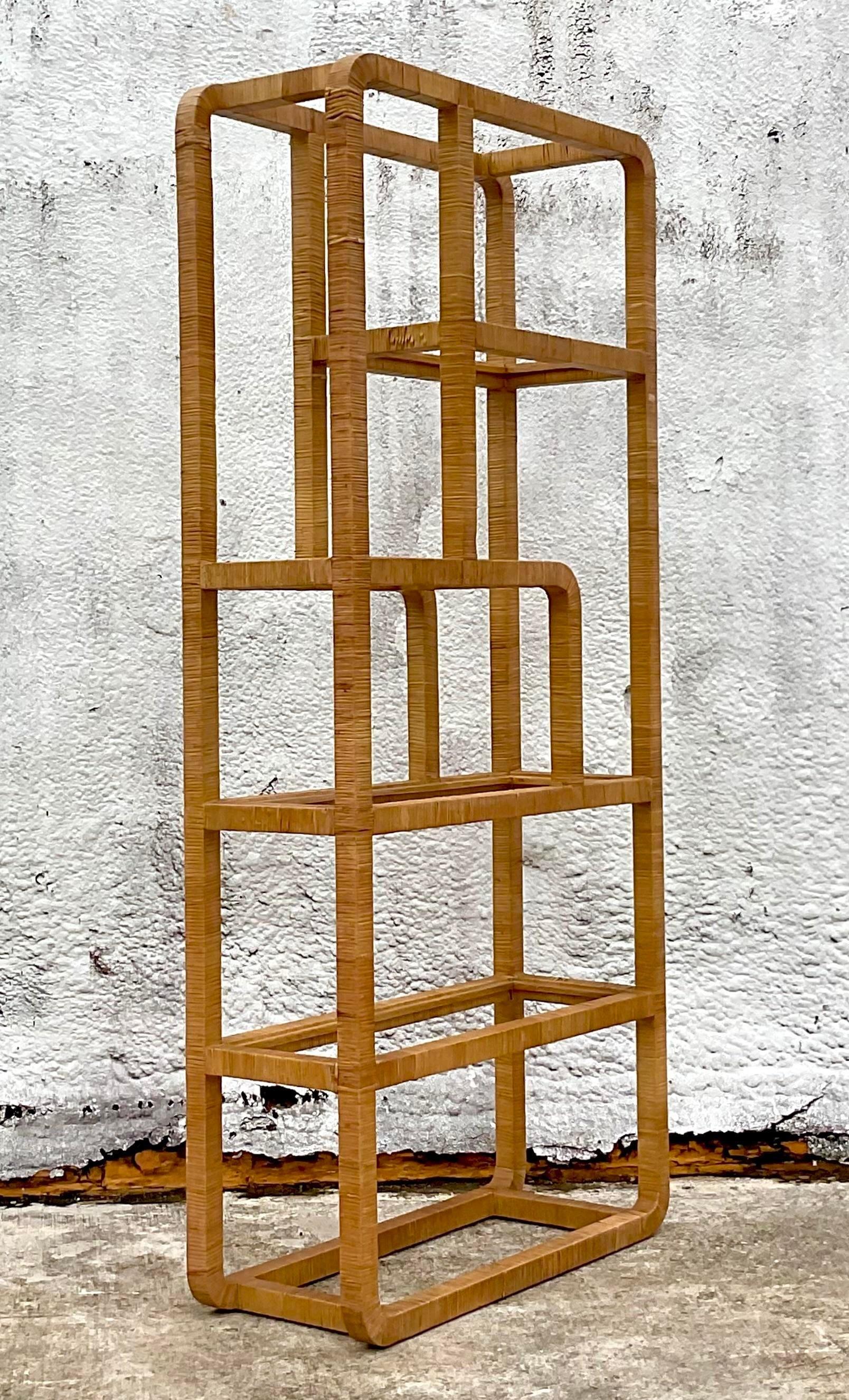 A fabulous vintage Coastal etagere. A chic wrapped rattan in an asymmetrical design. Inset glass shelves. Acquired from a Palm Beach estate.