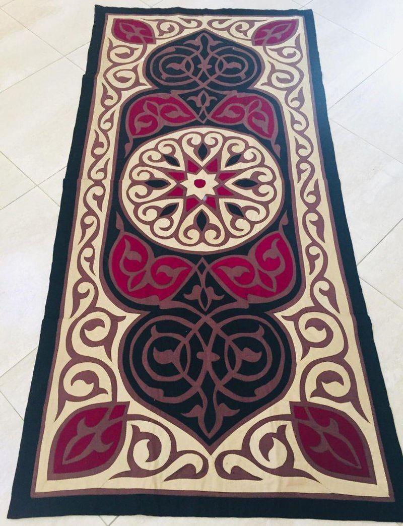 Middle Eastern end of the bed quilted textile with appliqué, elegant Moorish design in black, deep red and beige.
Ideal to use as a tablecloth on a centre or console table, on the back of a sofa or at the foot of a bed, as a wall hanging decoration,