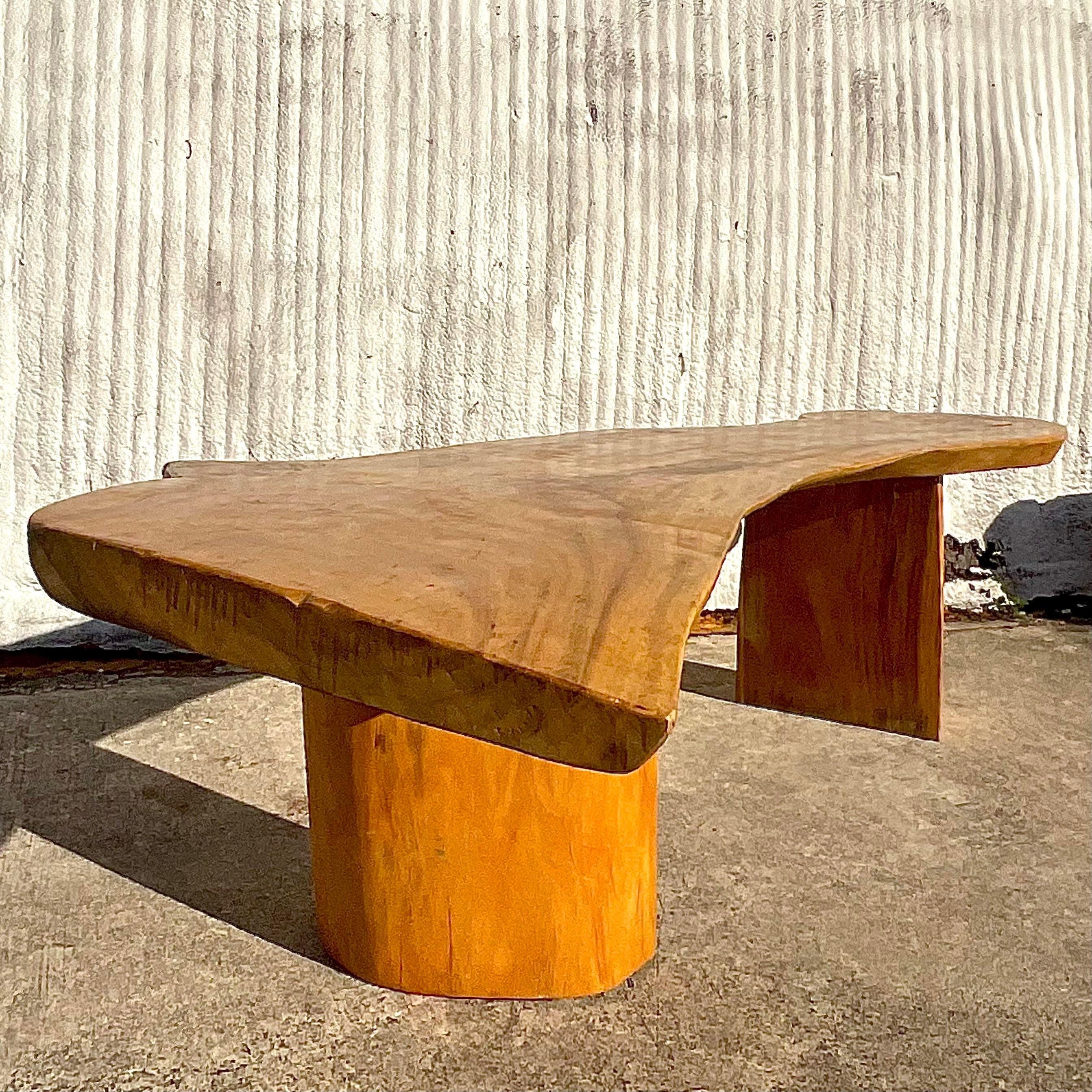A fabulous vintage Boho console table. A chic solid wood slap top with beautiful wood grain detail. A gorgeous sloped wood top.makes this table a real showstopper. Acquired from a Palm Beach estate.