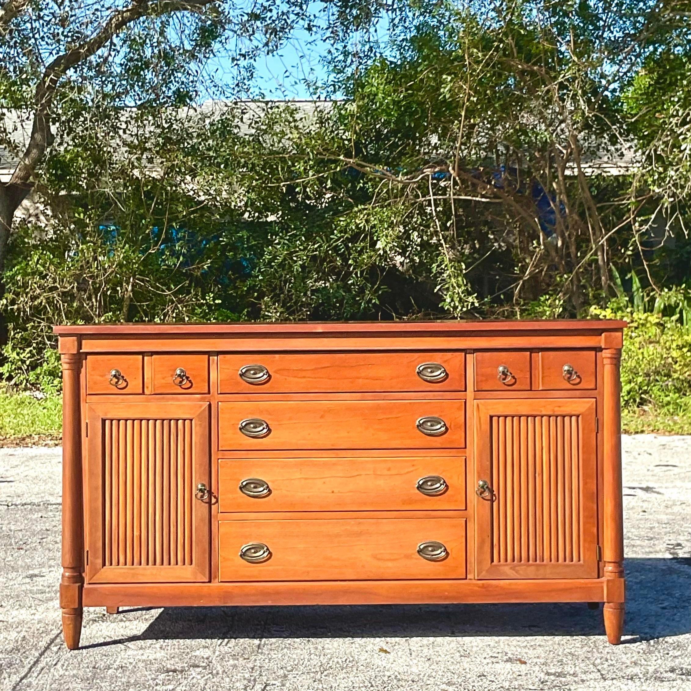 A fabulous vintage Boho credenza. Made by the Morganton group and tagged inside the drawer. A beautiful double door credenza with a beautiful warm wood finish. Lots of great storage below. Acquired from a Palm Beach estate.