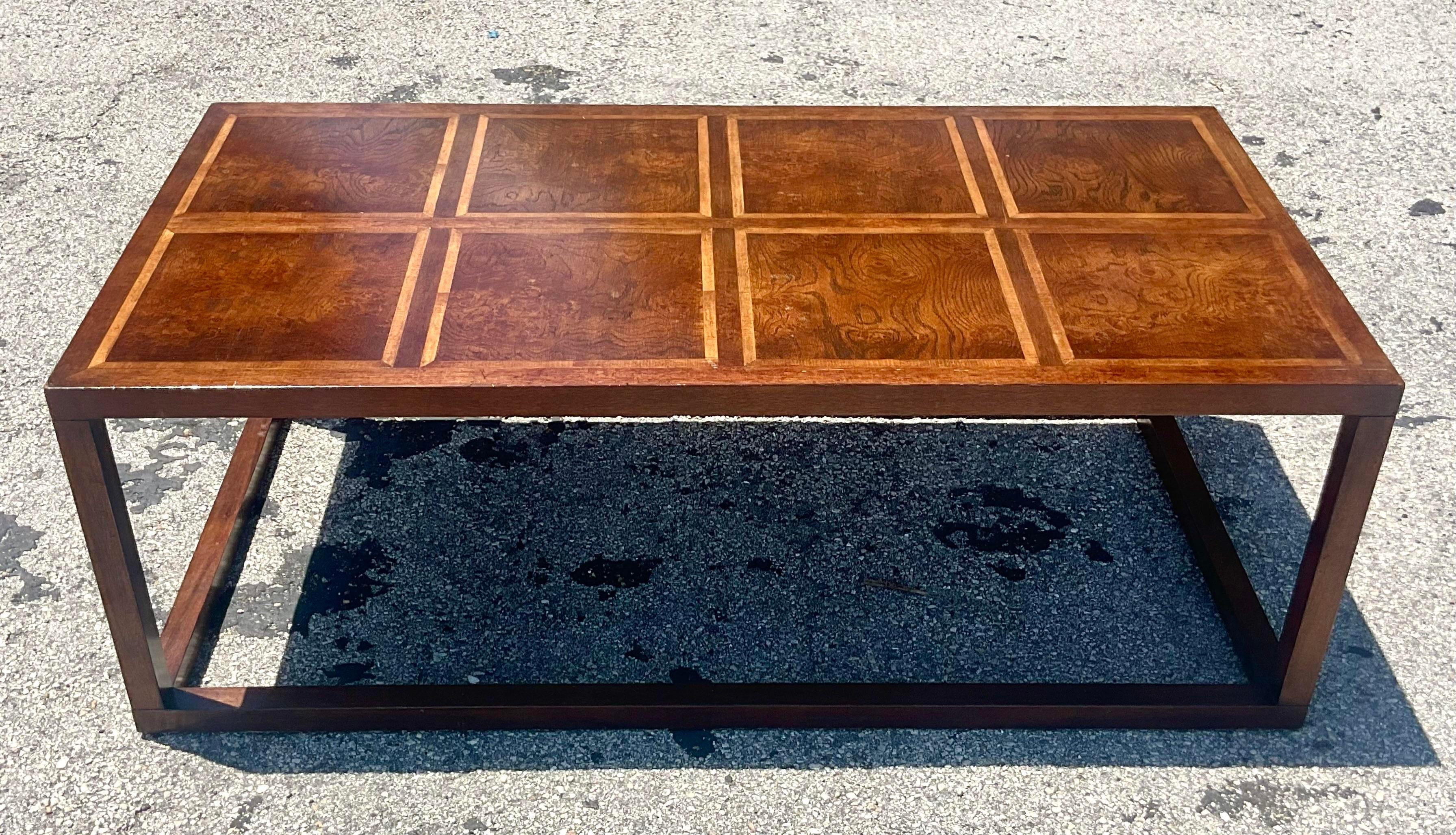 A vintage Regency wood Burl coffee table. Made by the iconic Baker Furniture group. Beautiful grid design with gorgeous wood grain detail. Tagged on the bottom. Acquired from a Palm Beach estate. 