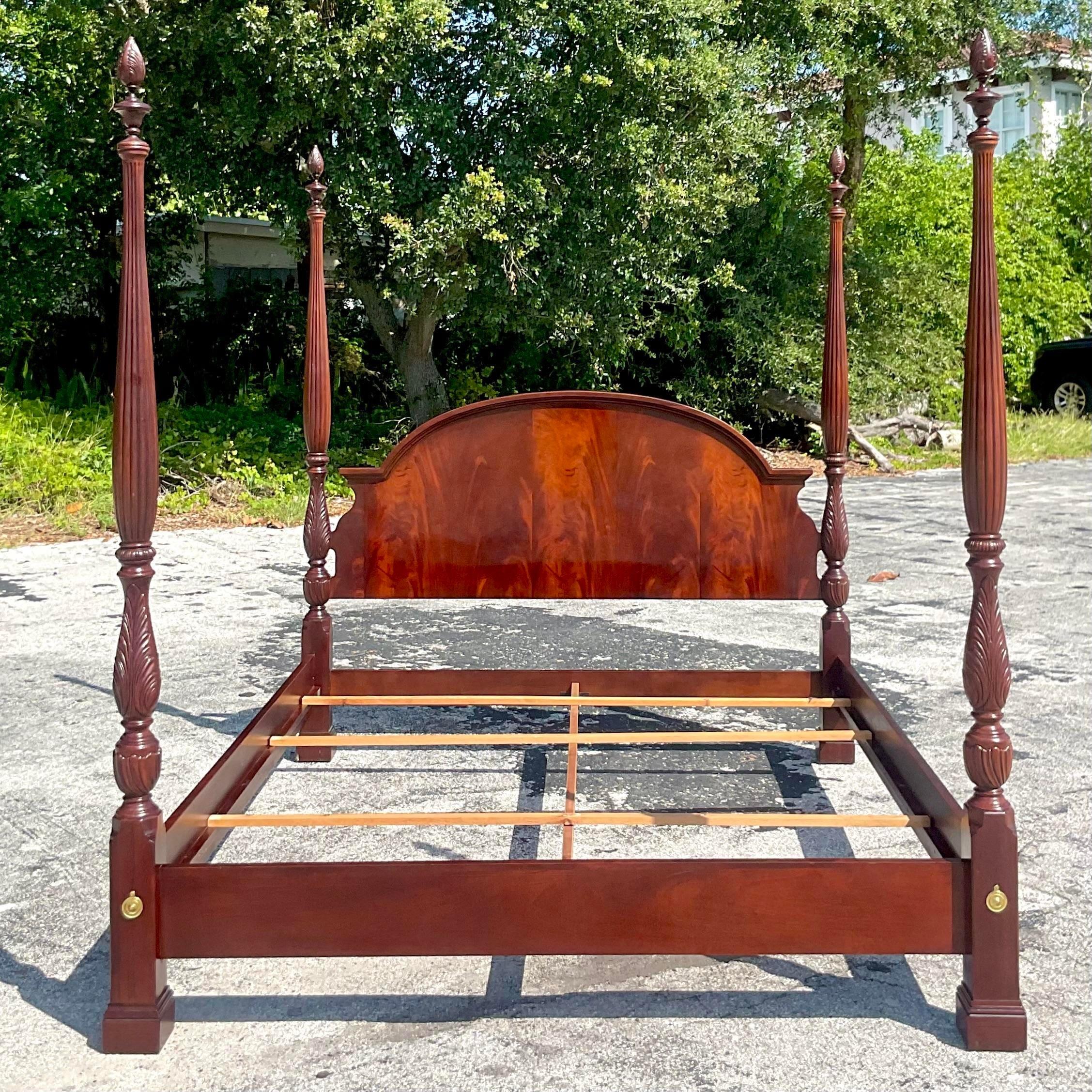 A stunning vintage Coastal King four poster bed. Made by the iconic Bernhardt group. A chic flame mahogany with beautiful hand carved detail. Acquired from a Naples estate. 
