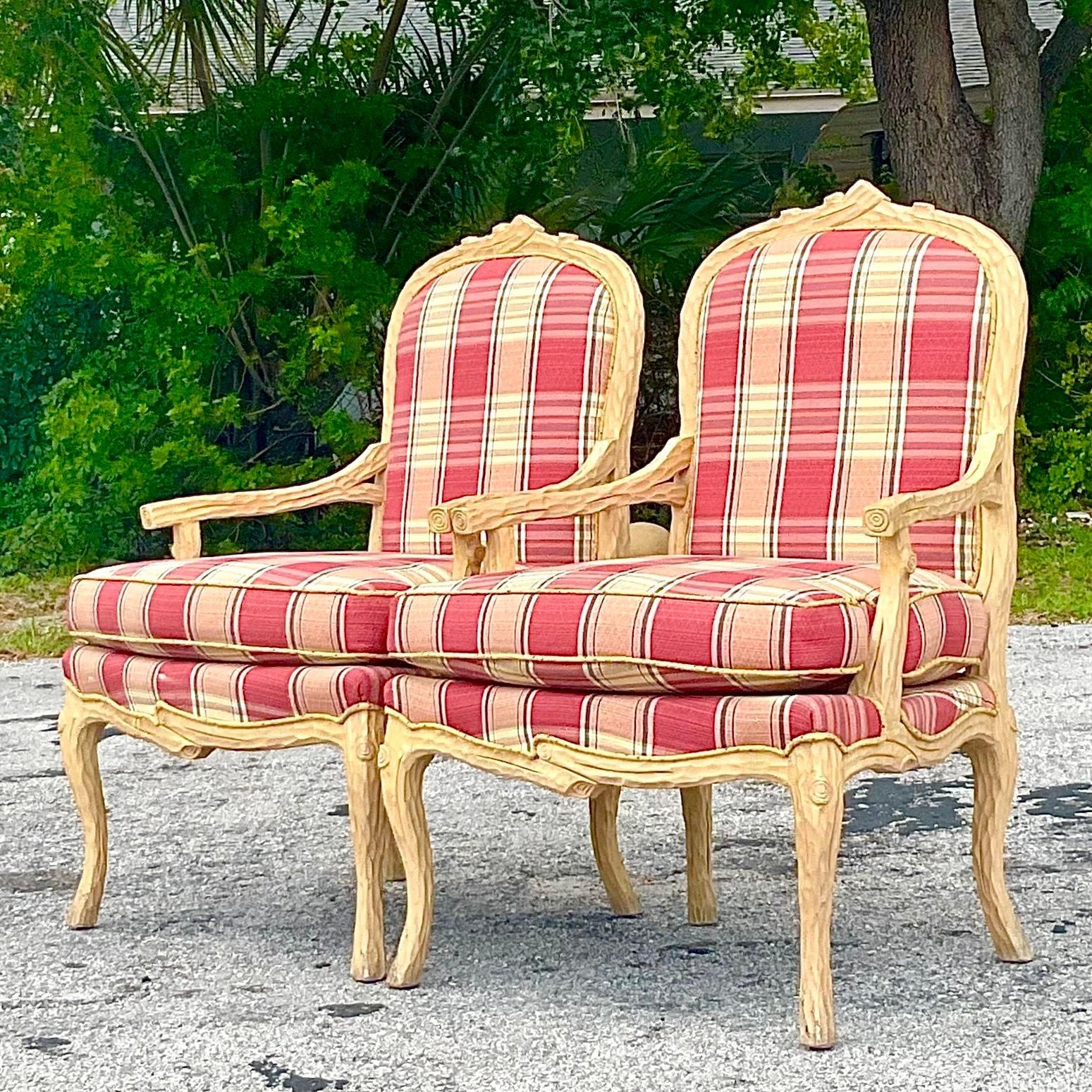 Add a touch of sophisticated charm to your décor with this pair of Vintage Regency Carved Faux Bois Bergere Chairs. These exquisite chairs blend American style with Regency elegance, featuring intricate faux bois carving and plush upholstery.