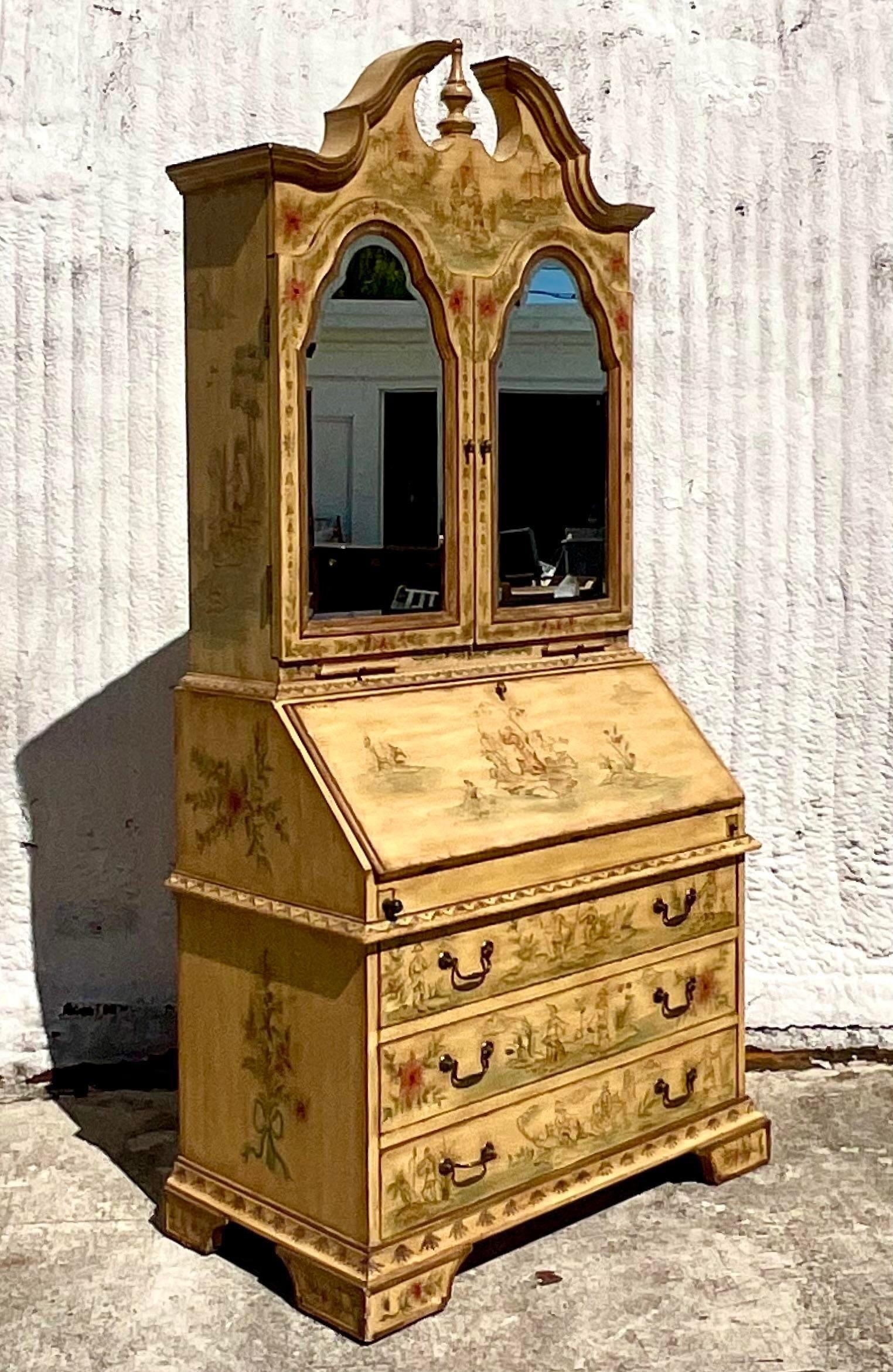 A stunning vintage Regency Secretary desk. Beautiful hand painted Chinoiserie detail on a saffron yellow background. Beautiful mirrored doors with a beveled edge. Lots of great little doors and drawers and a drop front desk surface. Acquired from a