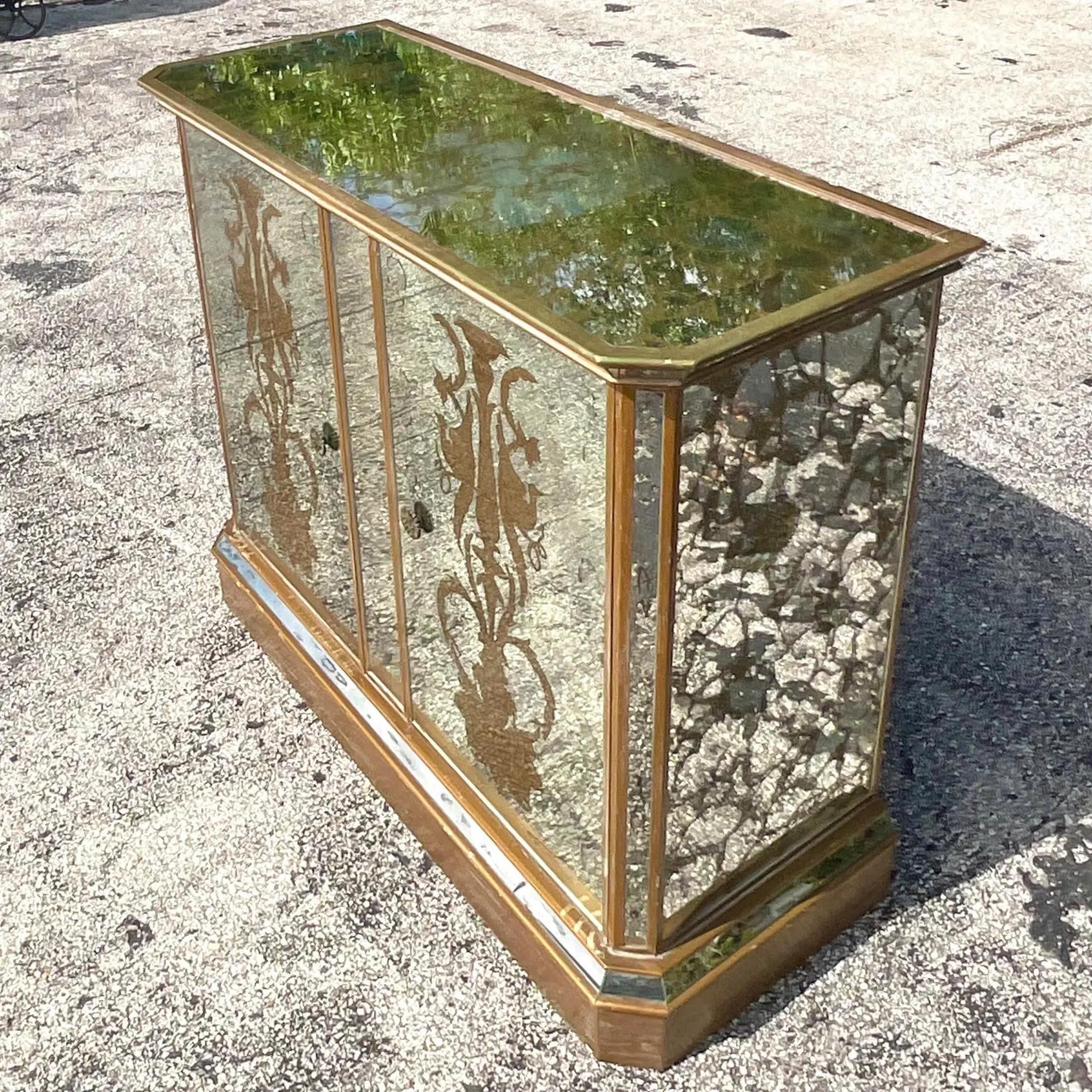 A fabulous vintage Regency dry bar. A chic Eglomise cabinet with a flip top and two interior spaces for liquor. The height of glamour. Acquired from a Palm Beach estate