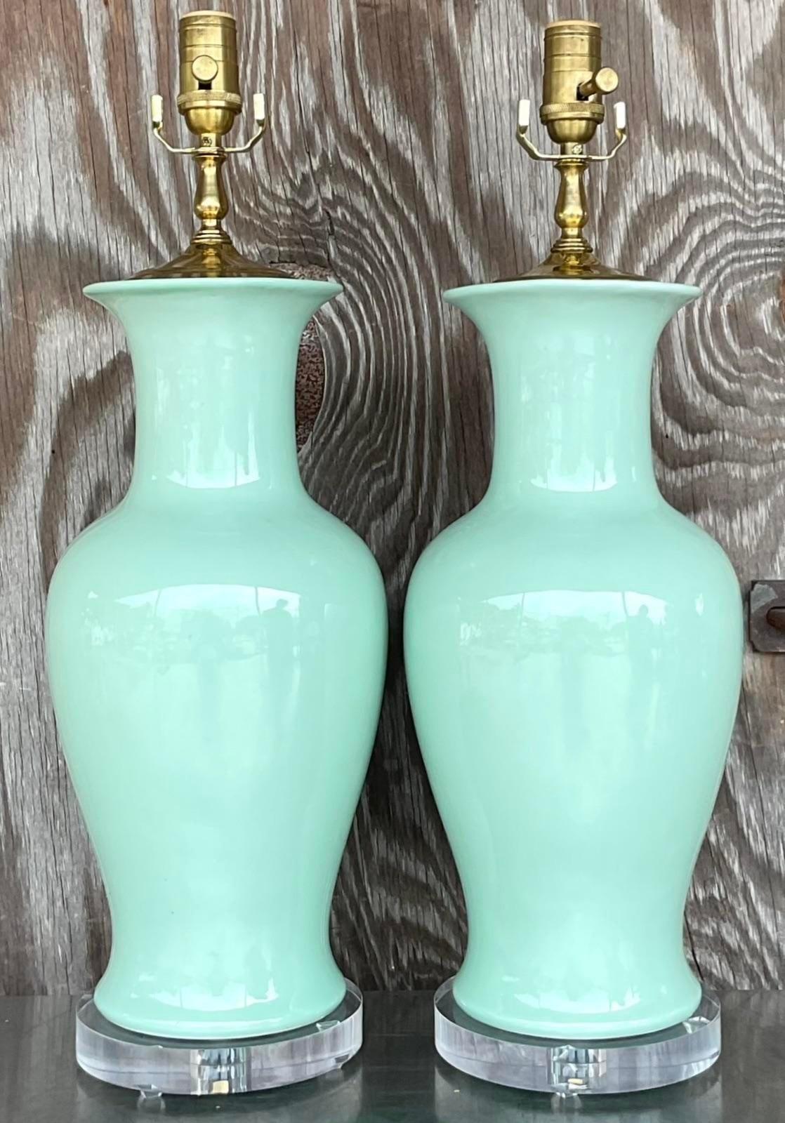 A fabulous pair of vintage Regency table lamps. A chic glazed ceramic in a fresh minty green. Fully restored with all new hardware, wiring and lucite plinths. Acquired from a Palm Beach estate.