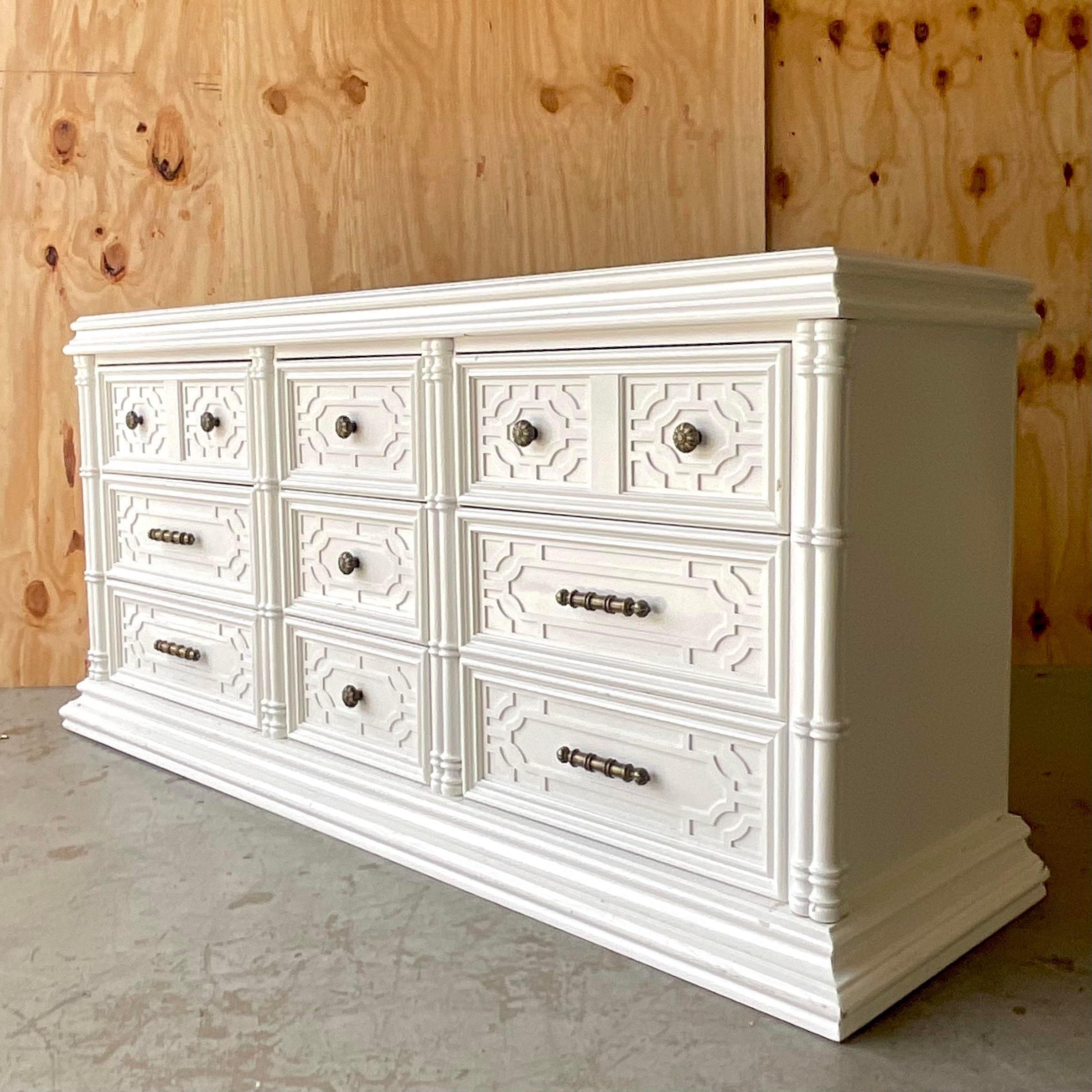 A fabulous vintage Regency 9 drawer dresser. Made by the iconic Thomasville group. Beautiful bright white lacquered finish with heavy brass hardware. Acquired from a Palm Beach estate.