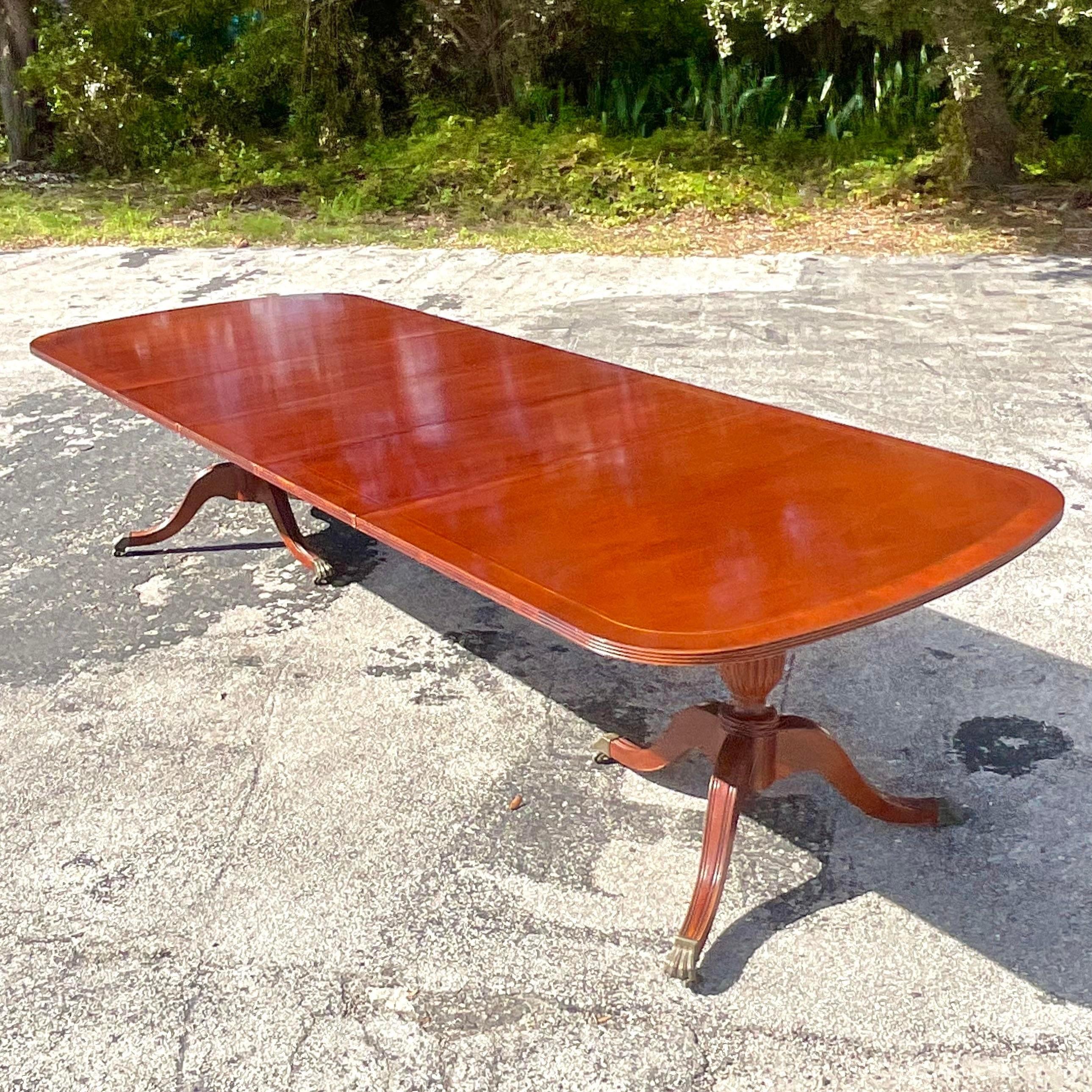A fabulous vintage Regency dining table. Made by the iconic Lexington group and tagged on the bottom. Additional leaves for a total of 120 possible length. Acquired from a Hobe Sound estate. 
