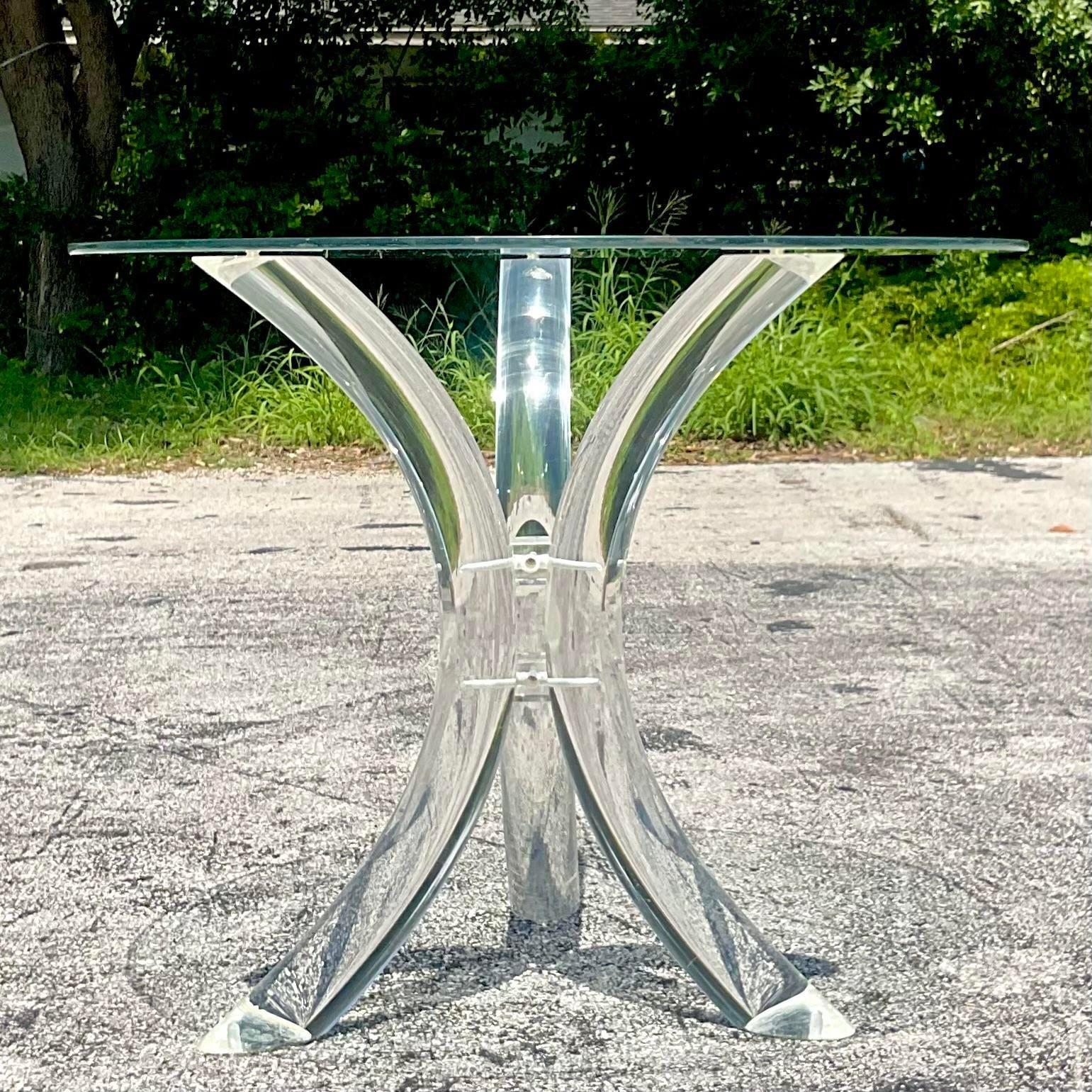A fabulous vintage Regency center hall table. A chic lucite tripod shape with a glass top. Can easily support a larger piece of glass. Two tables available if a pair is needed. Acquired from a Palm Beach estate.