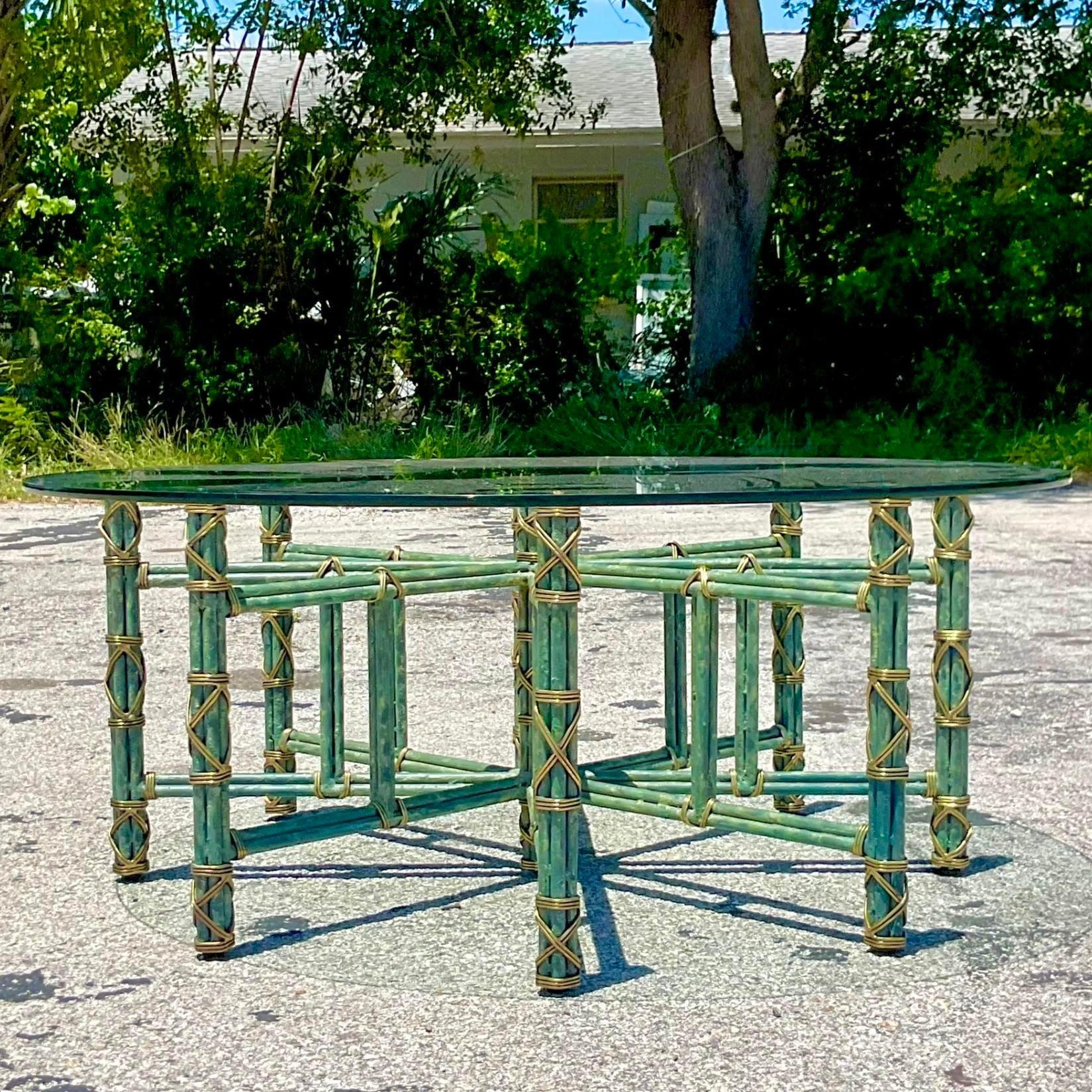 A fabulous vintage Regency coffee table. Made by the iconic Maitland Smith group..A chic patinated metal in a brilliant verdigris finish. Brass wraps at the joints. Acquired from a Palm Beach estate.