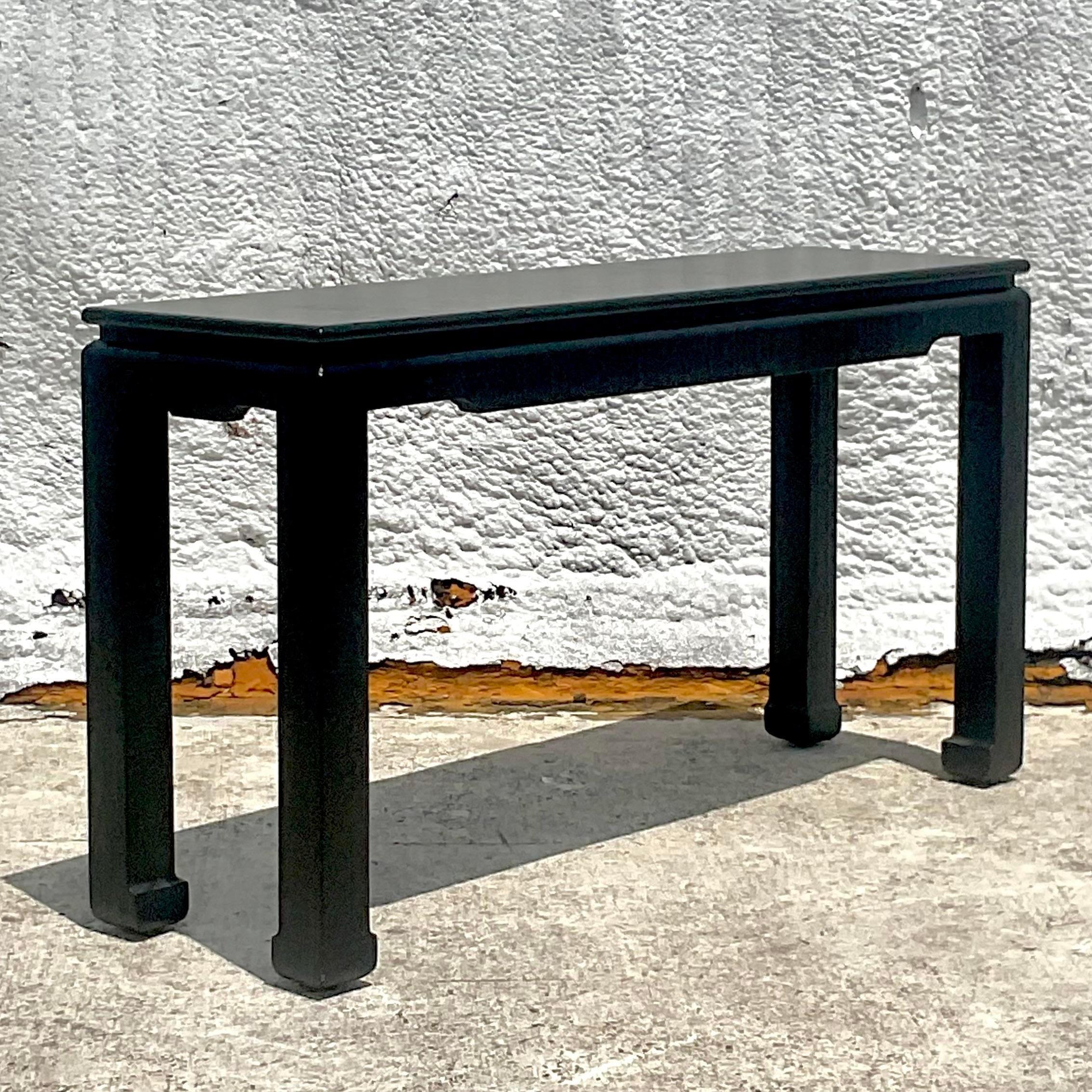 A fabulous vintage Regency console table. A chic Grasscloth finish with Ming legs. Currently black, but easy to change the color to suit your project. Acquired from a Palm Beach estate.