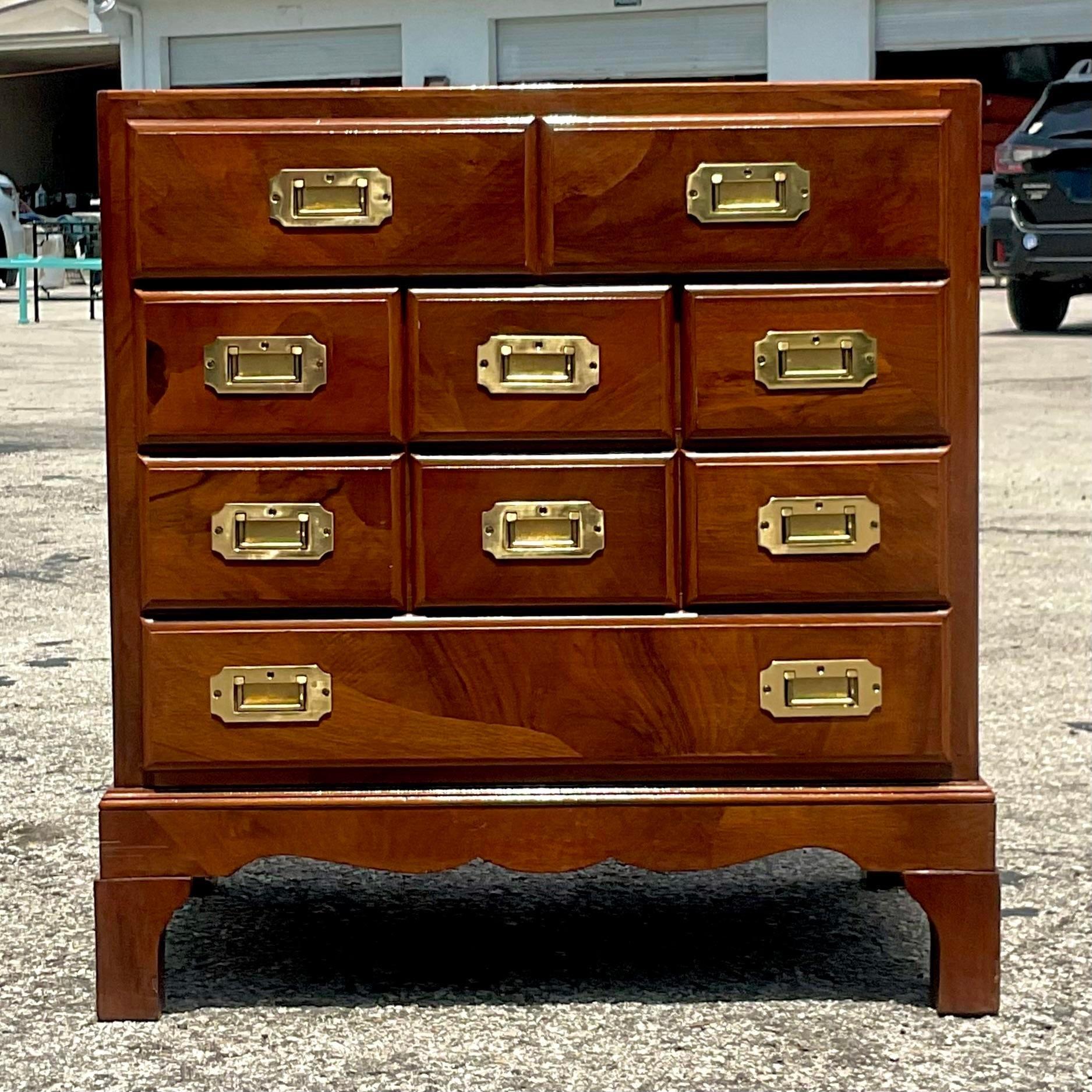 A gorgeous vintage Petite Campaign chest of drawers. A chic little cabinet with a beautiful patchwork design. Classic campaign brass hardware. Finished on all sides so sits beautifully in an open space. A real workhorse that can be used as a side
