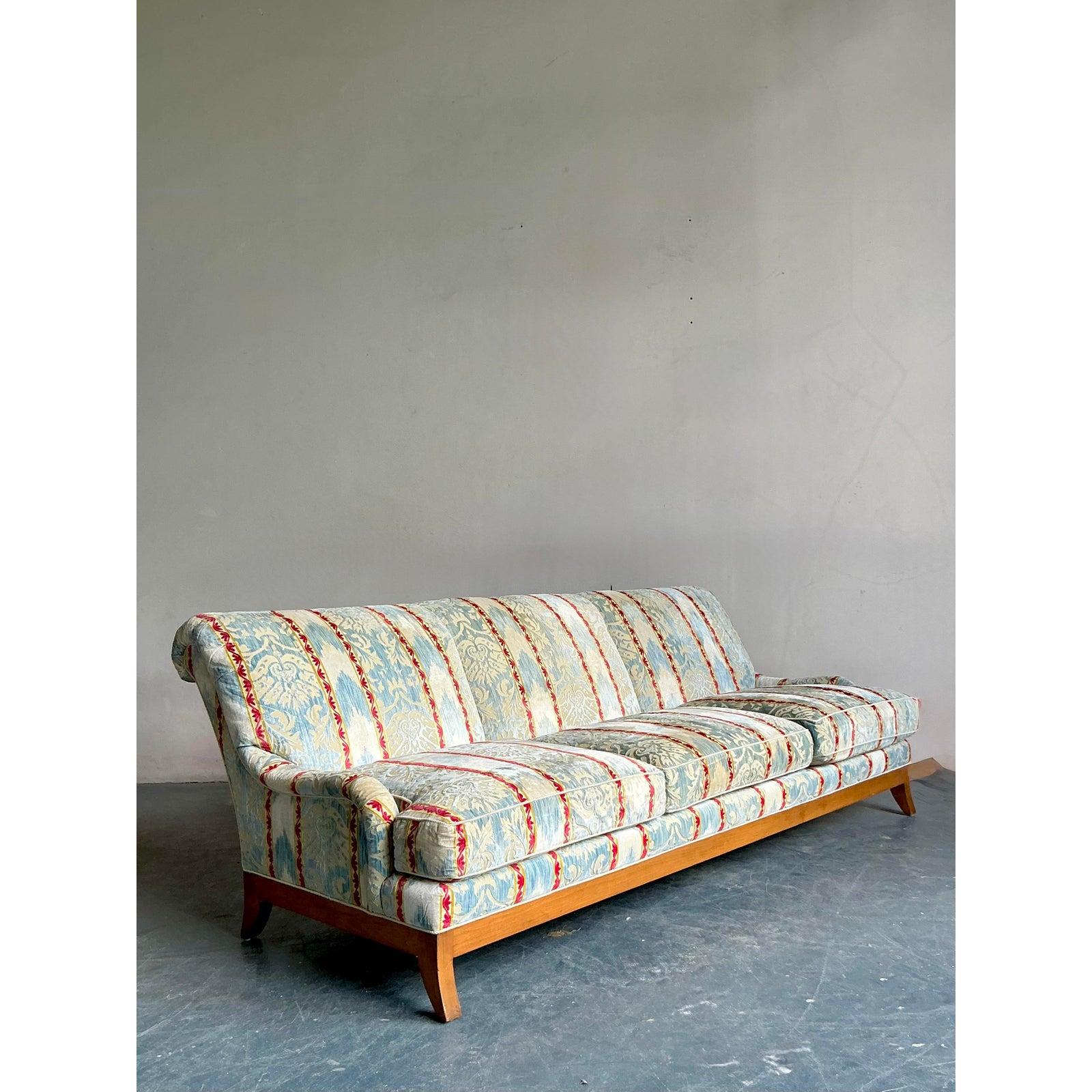 Elegant and captivating, this Vintage Regency Cut Velvet Sofa is a testament to timeless design and luxurious comfort. Its classic silhouette, defined by clean, graceful lines and a beautifully exposed wood frame, exudes a refined sensibility. The