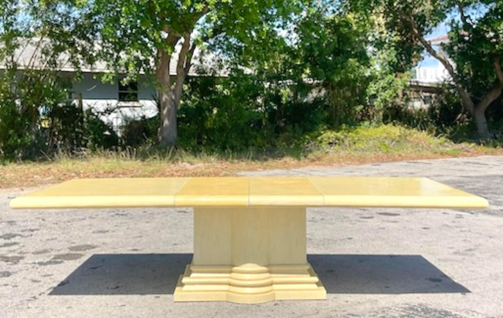 A spectacular vintage Regency dining table. Chic hand placed tessellated bone tile on a infinity edge top. Stacked column pedestal. Two additional leaves for maximum seating. Acquired from a Palm Beach estate.

Extended length 114.