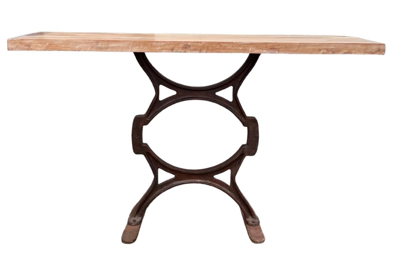 This narrow console table would be lovely used as an entryway table, placed behind a sofa, or in a narrow hallway. The old cast iron base was originally used in a factory, giving this piece an enormous amount of authenticity. The new wood top adds a