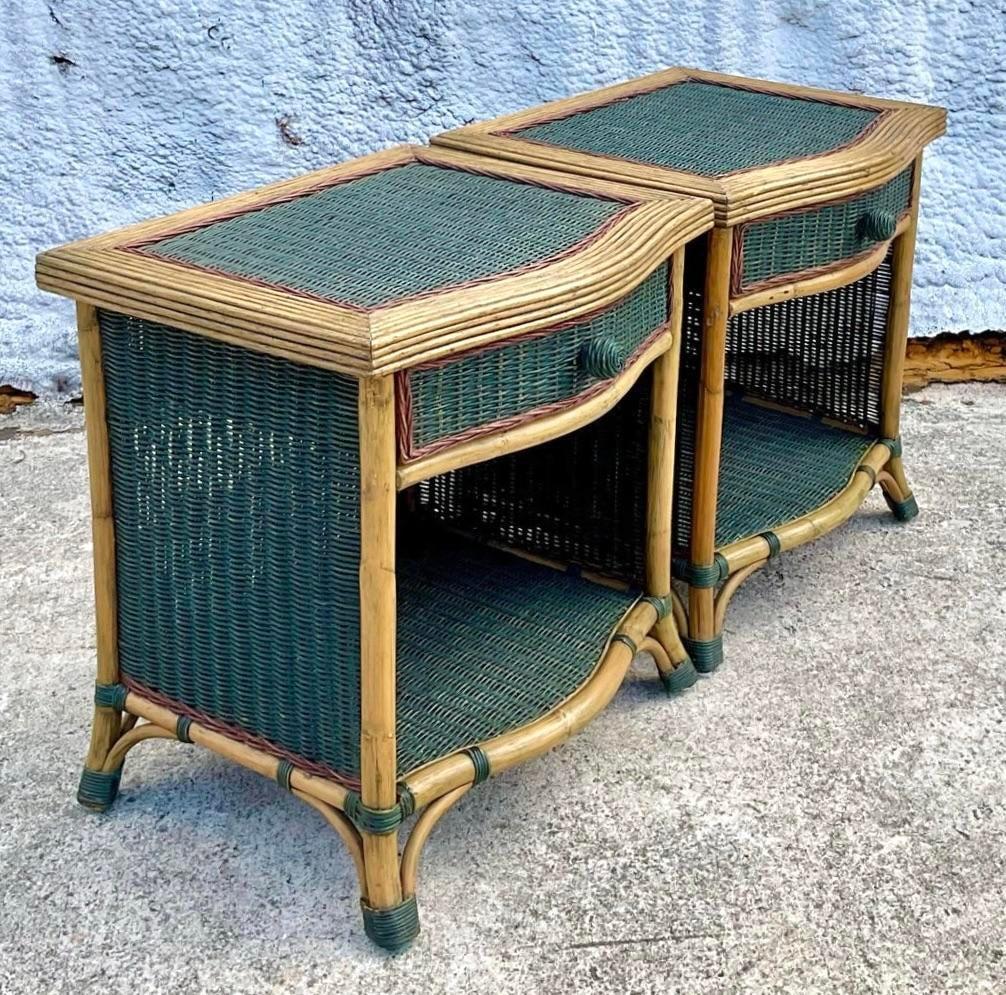 A lovely pair of vintage woven rattan nightstands stained in a dark green and maroon shade. They both have one drawer and shelf to keep you things. Acquired at a Palm Beach estate. 
