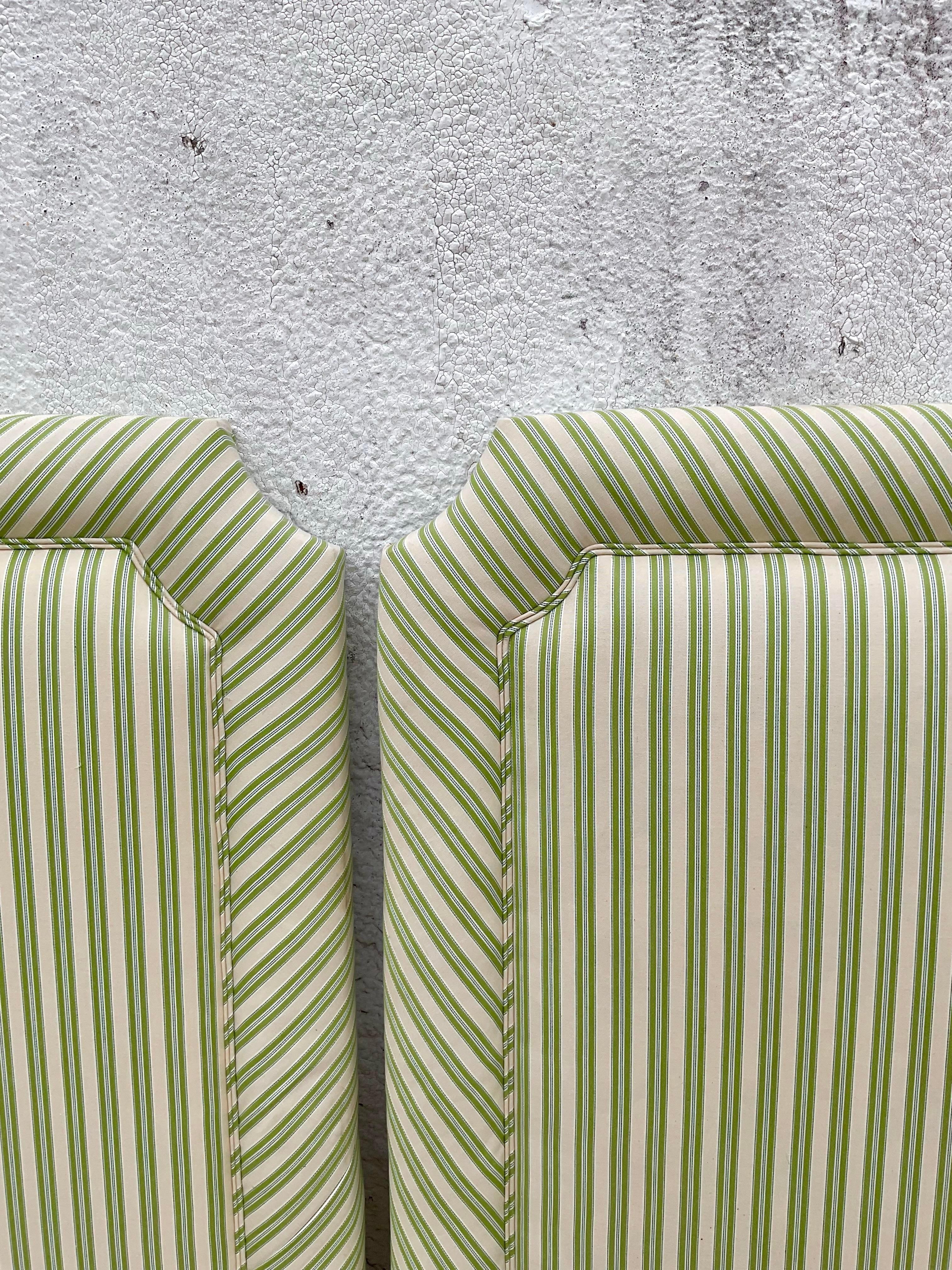 A gorgeous pair of vintage twin sized headboards. In a lovely ticking pattern of green and white fabric with double piping trim outlining the clean shape. Acquired at a Palm Beach estate. 