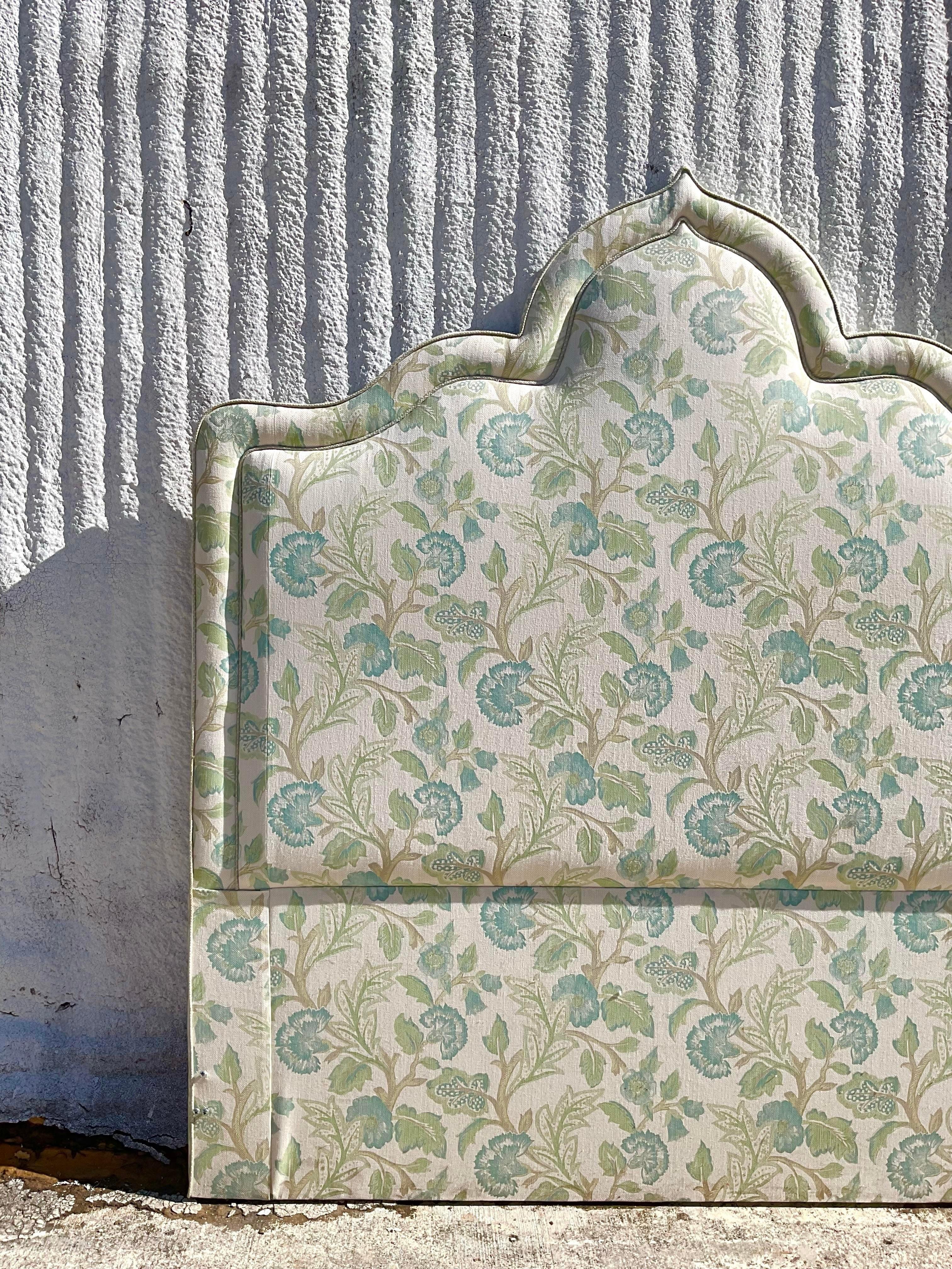 A fabulous vintage headboard upholstered in a floral fabric. Beautiful piping trim detailing. Acquired at a Palm Beach estate.