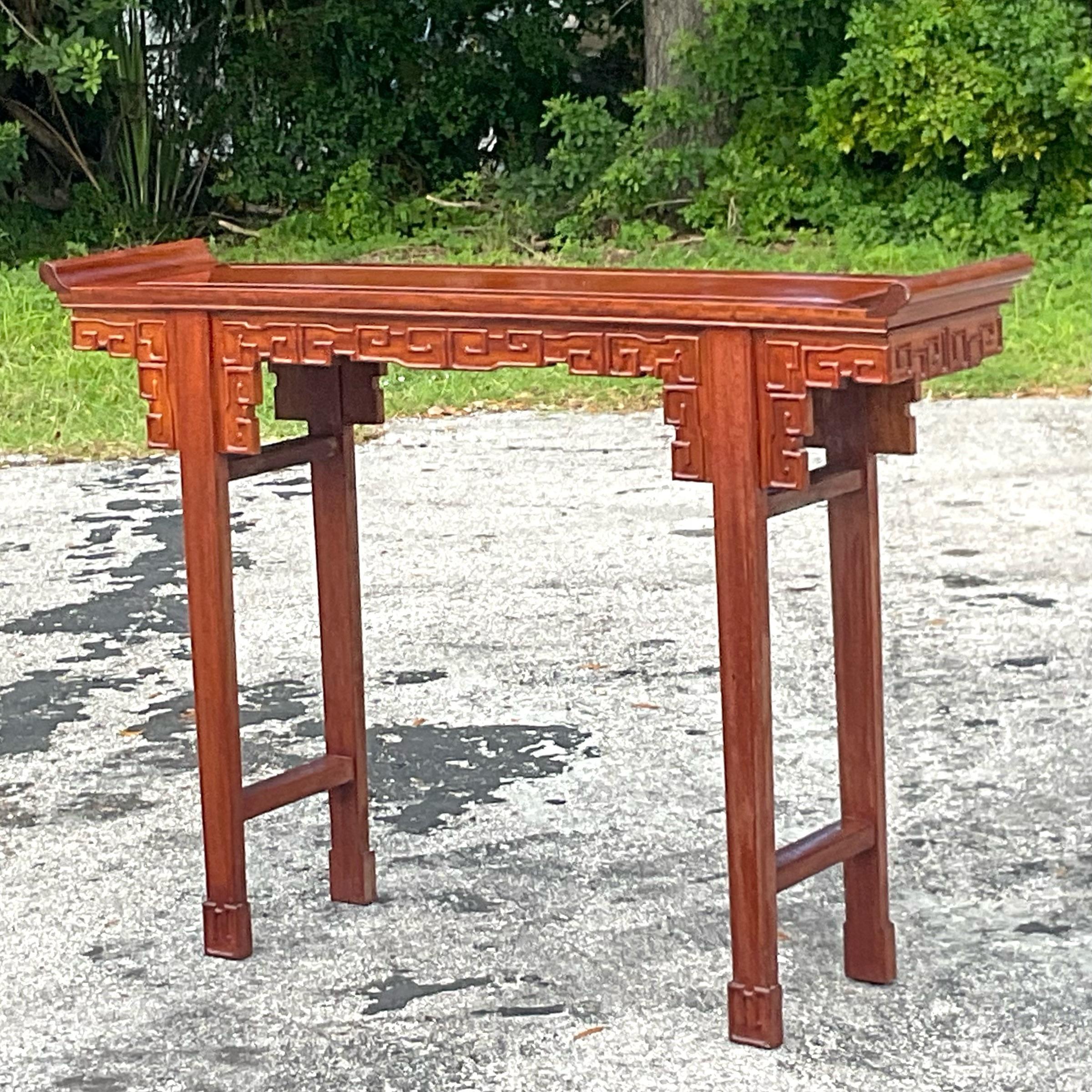 Beautiful vintage chinoiserie altar table with intricate details in the wood and the classic winged curved sides. Perfect to add an element of sophistication and collection to any space. Acquired from a Palm Beach Estate.