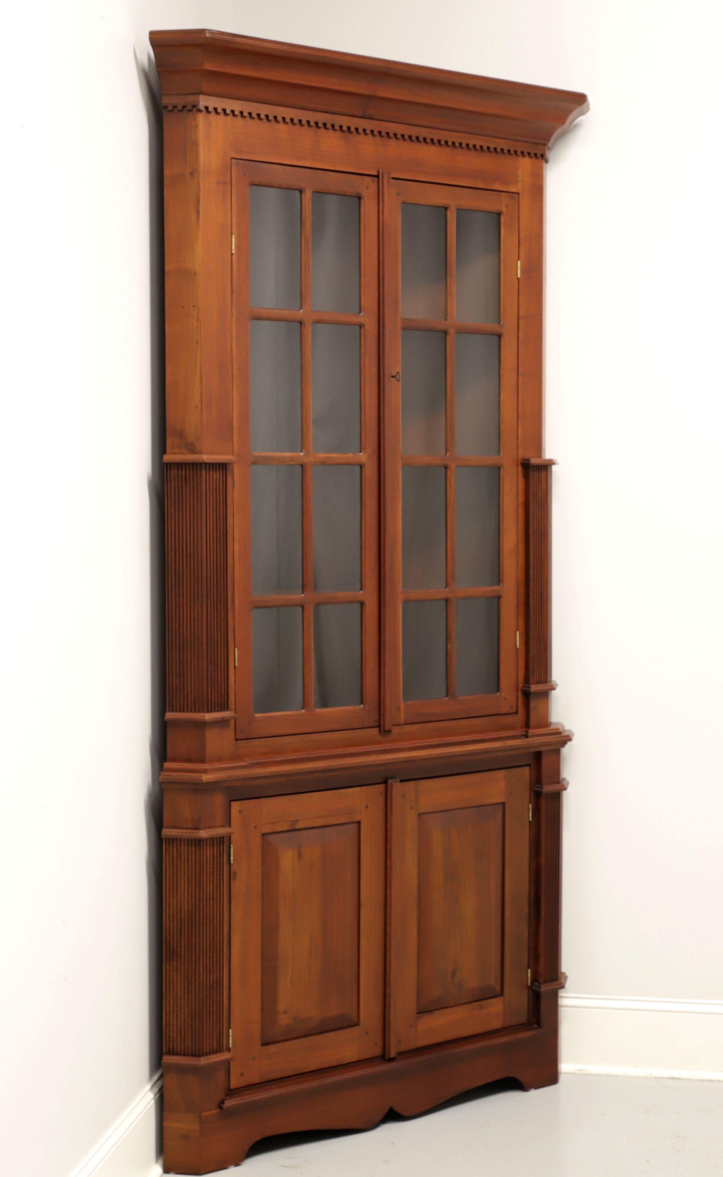 An extra tall Chippendale style corner cabinet, unbranded. Solid walnut with brass hardware, crown & dentil molding, fluted side columns and bracket feet. Upper cabinet features three fixed wooden display shelves behind a pair of paned glass doors.