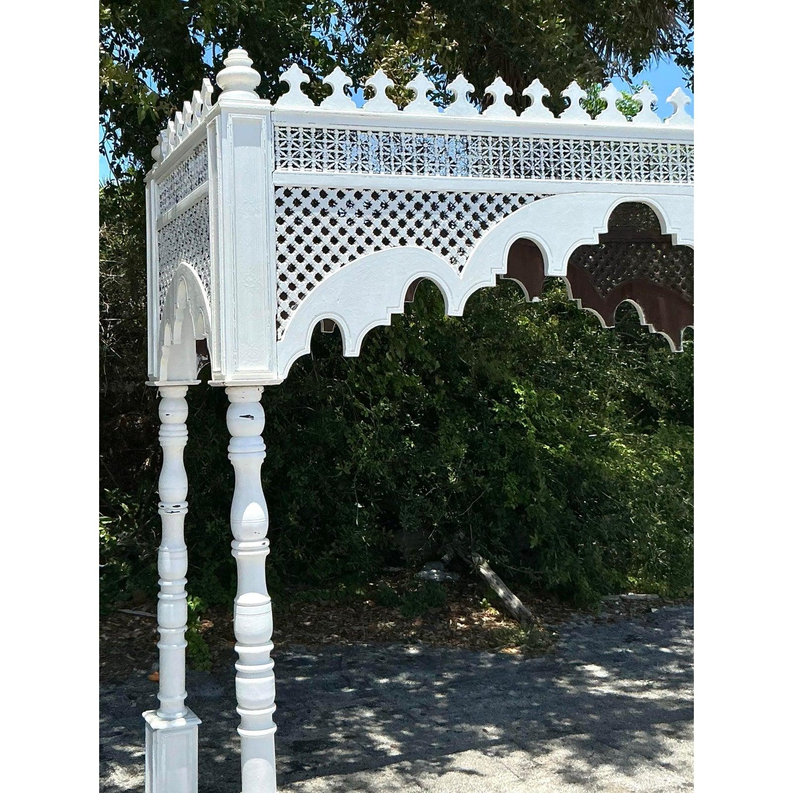 Transform any space into an exotic sanctuary with this magnificent Vintage Carved Canopy, a truly unique architectural statement piece. Crafted with extraordinary detail, this ornate wooden canopy features intricate fretwork, elegant quatrefoil
