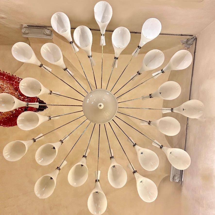 Stunning spiderweb round XXL chandelier with 24 white blown Murano glass conical diffusers (size of each diffuser: 21 Diam. x 47 H cm.) The central rod has a white opaline glass cylinder in it.
24 G9 Led Stick Light Bulbs for the glass diffusers +