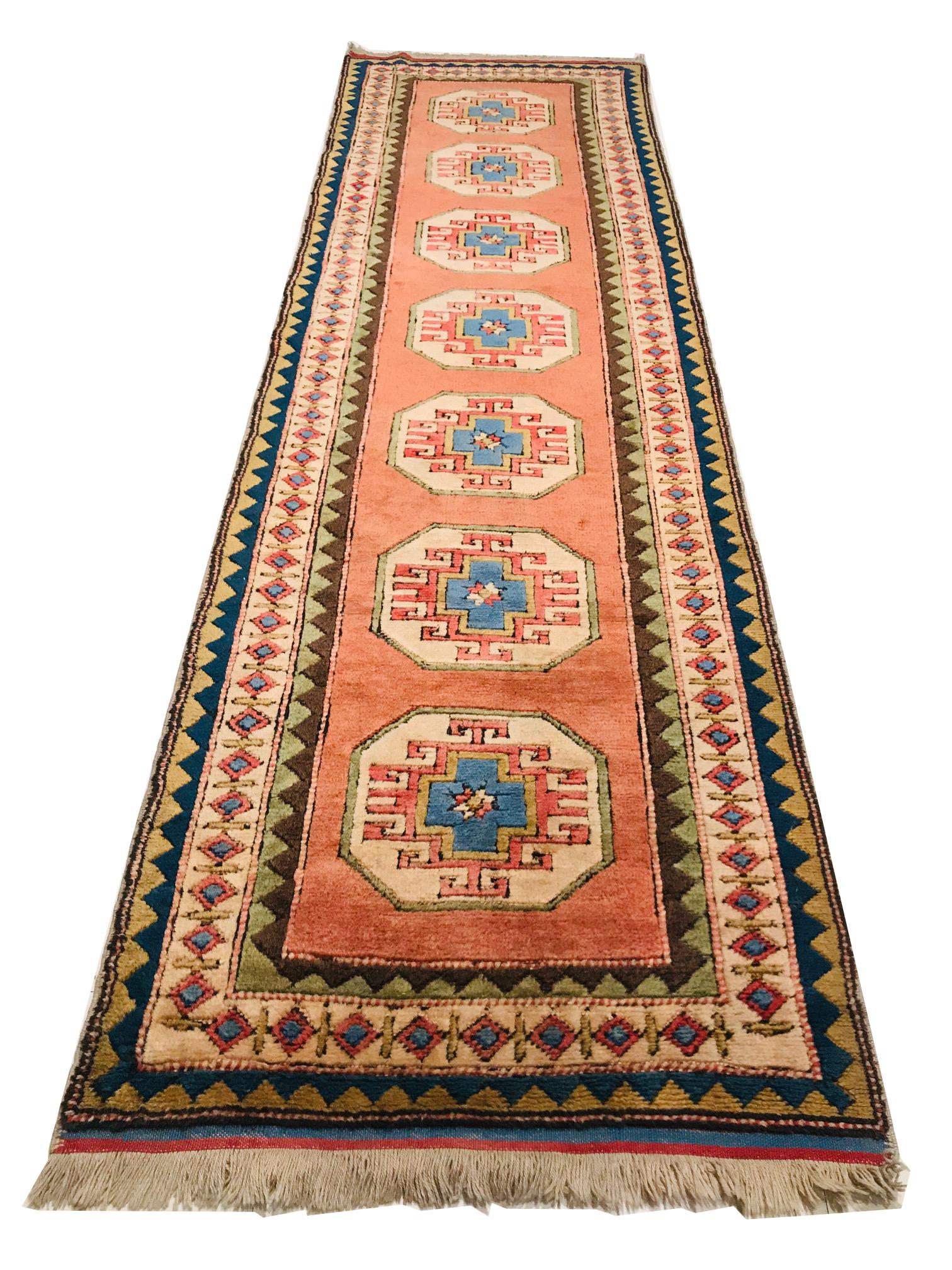 This Turkey runner rug is from the 1980s, hand knotted with wool.
This runner carpet has typical geometric drawings of this period, a combination of colors such as orange, black, blue, brown, olive green and beige that makes it a perfect piece to