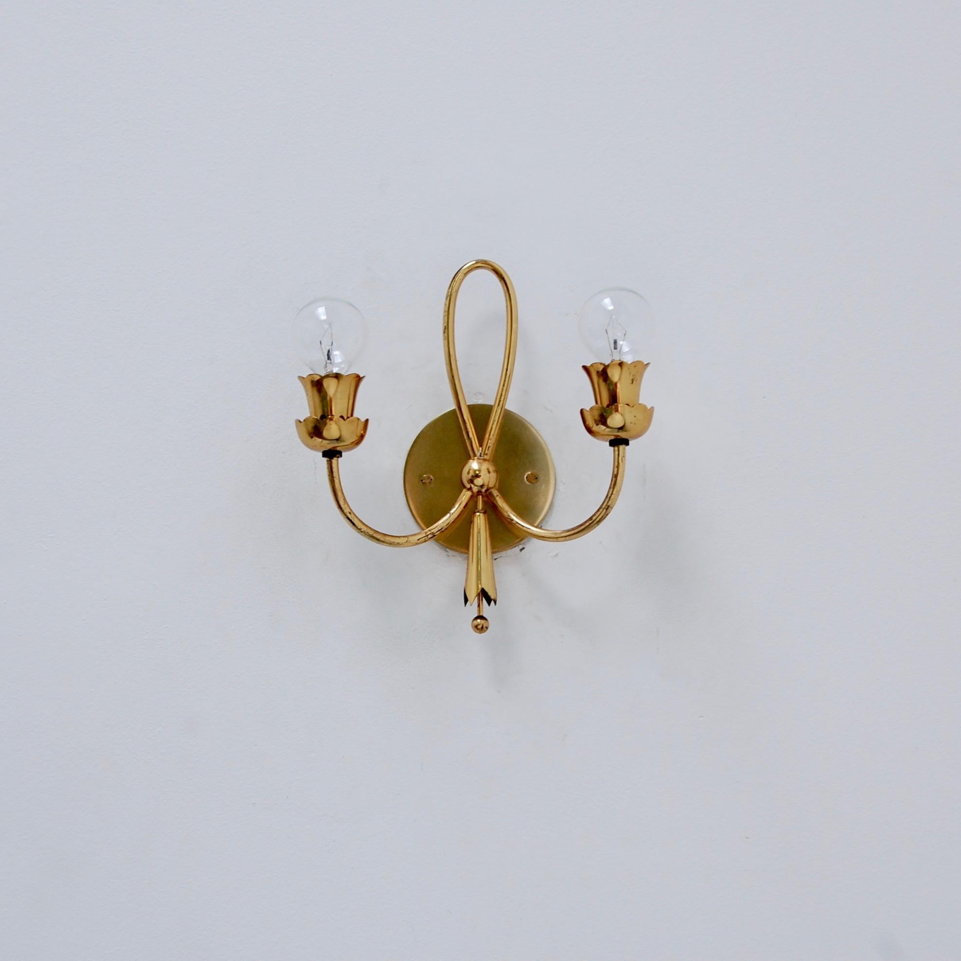 Iconic late 1940s Italian brass sconces in a botanical motif. (2) candelabra based sockets per sconce. Partially restored, and rewired for use in the US. Light bulbs supplied with order. We can also rewire for any country upon request. Priced as a
