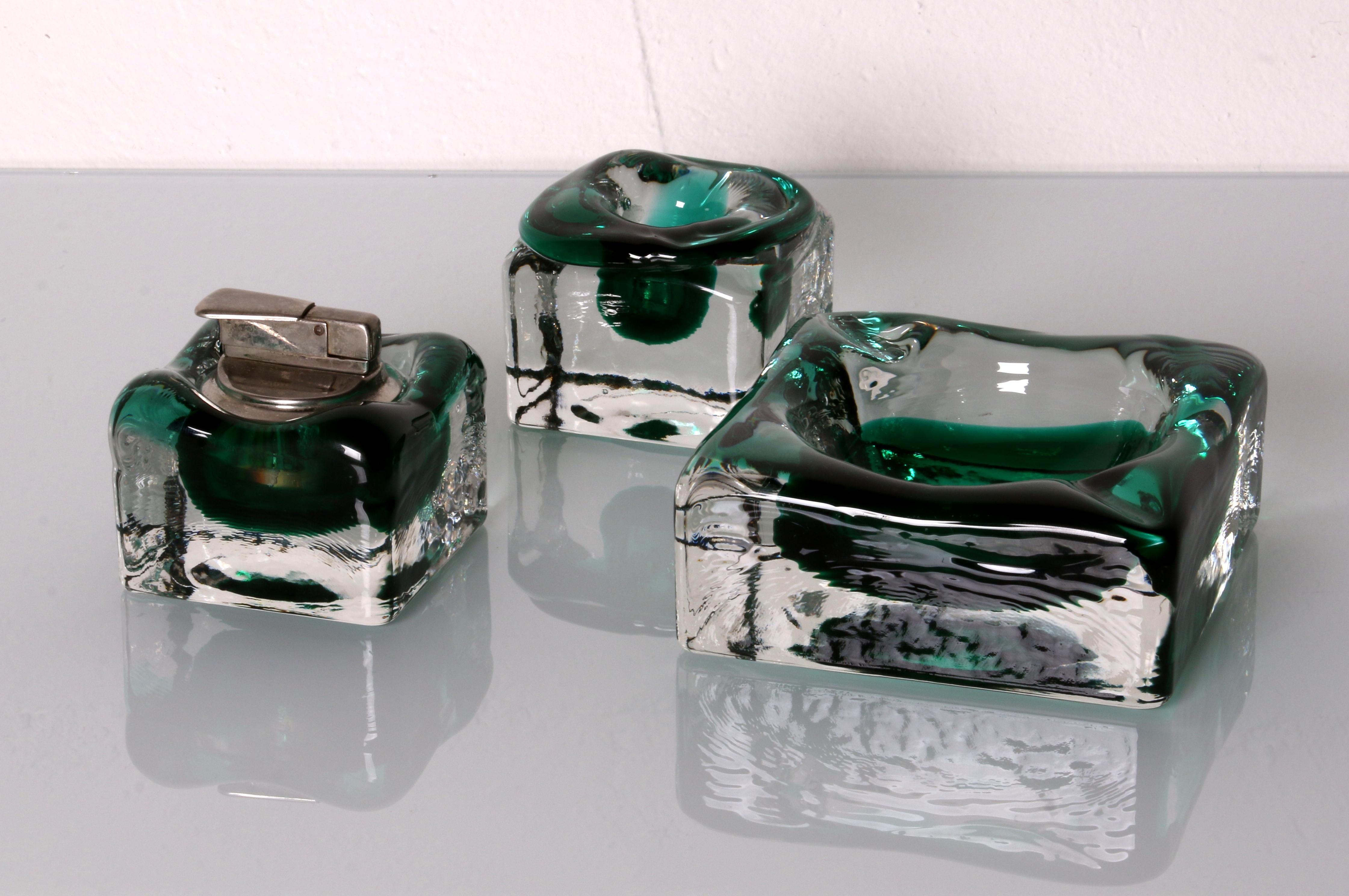 
late 1960s / early 1970s

SET 
of an ashtray a candle holder and a lighter
 
Sommerso, an Italian term signifying 
