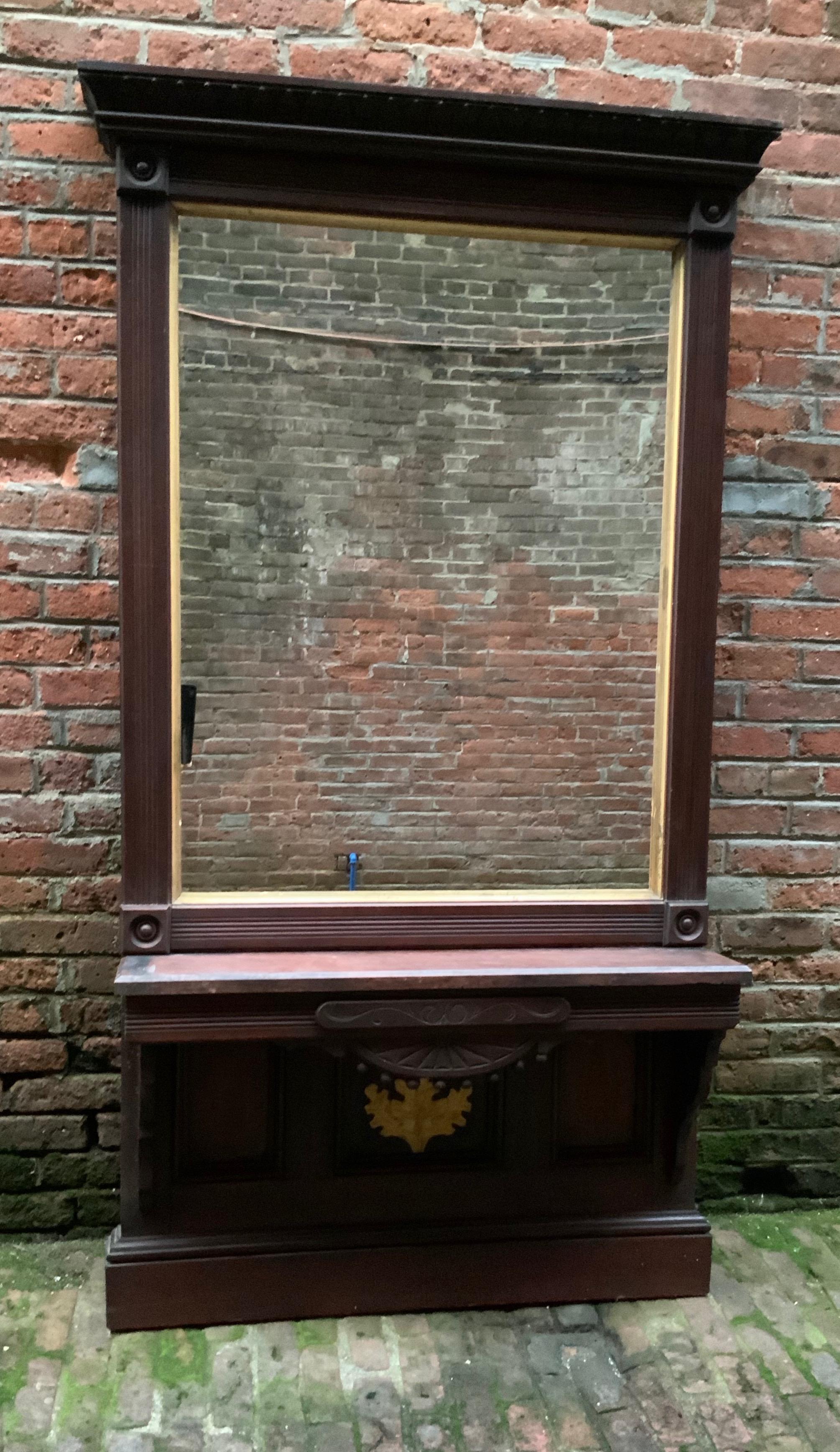 Massive solid walnut with red marble pier mirror. Refined elegance with reeded molding, gilded fillet with oak leaf cluster detail, circa 1870-1890. Original finish. New mirror. The pier mirror previously resided in a large New Rochelle, NY