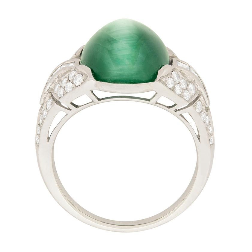 This mystical ring features a rare 10.75 carat cat's eye tourmaline. It is a blueish green colour with a well defined cat's eye. Cat's eye effect in tourmaline is rare, and is generally not as refined as the cat's eye seen in this stone, making this