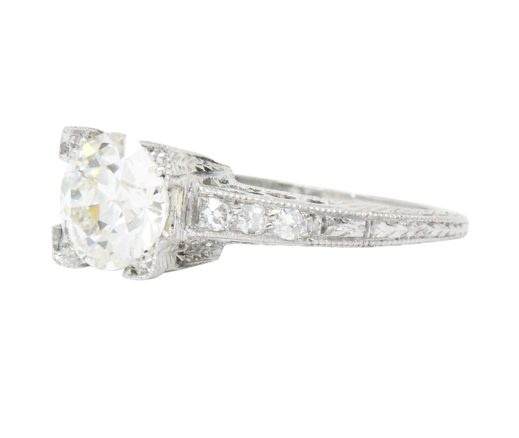 Centering a round brilliant cut diamond weighing 1.02 carats, K color with VS1 clarity

Flanked by bead set single cut diamonds weighing approximately 0.15 carat total; H/I color with VS to SI clarity

Featuring a square form head, milgrain detail,