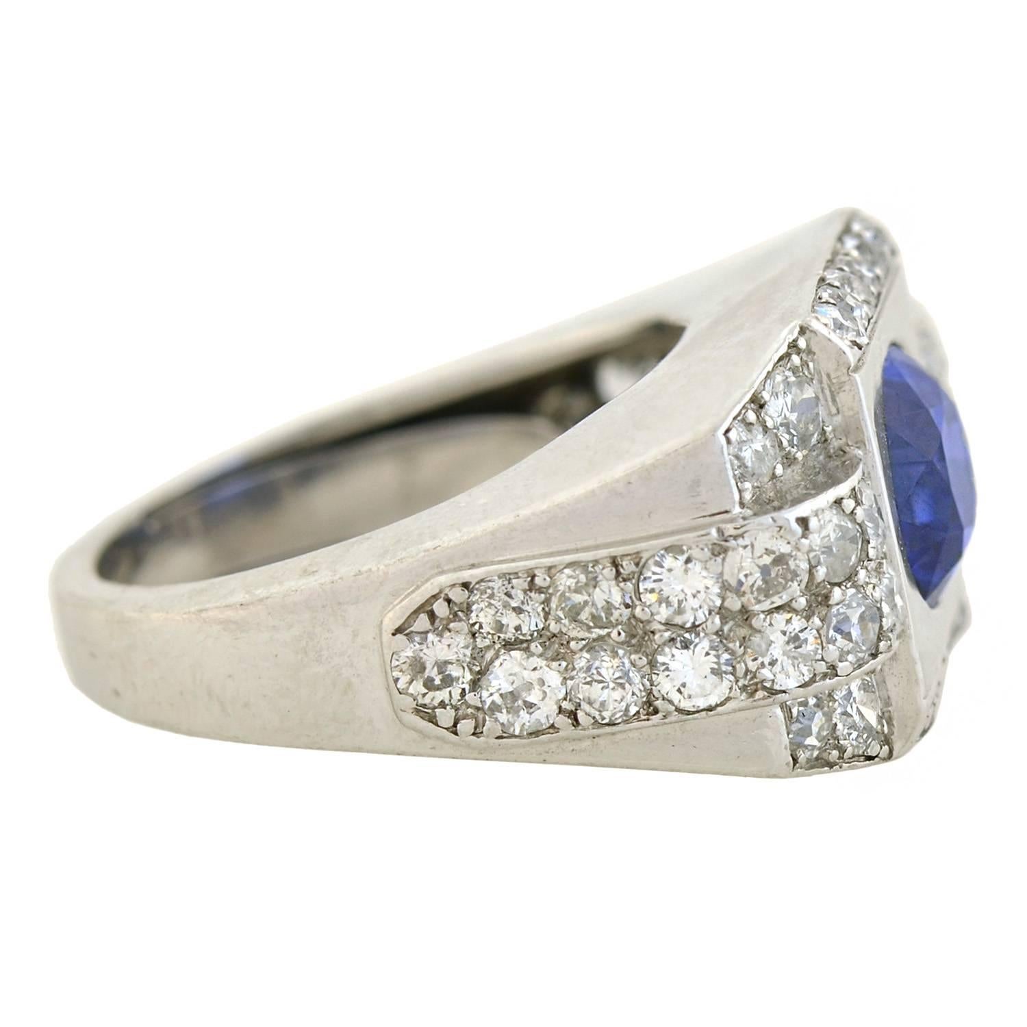 An absolutely fantastic natural sapphire and diamond ring from the late Art Deco (ca1930s) era! The ring, which is crafted in platinum and French in origin, displays a natural sapphire set within a bold and striking mounting. The natural Ceylon (Sri