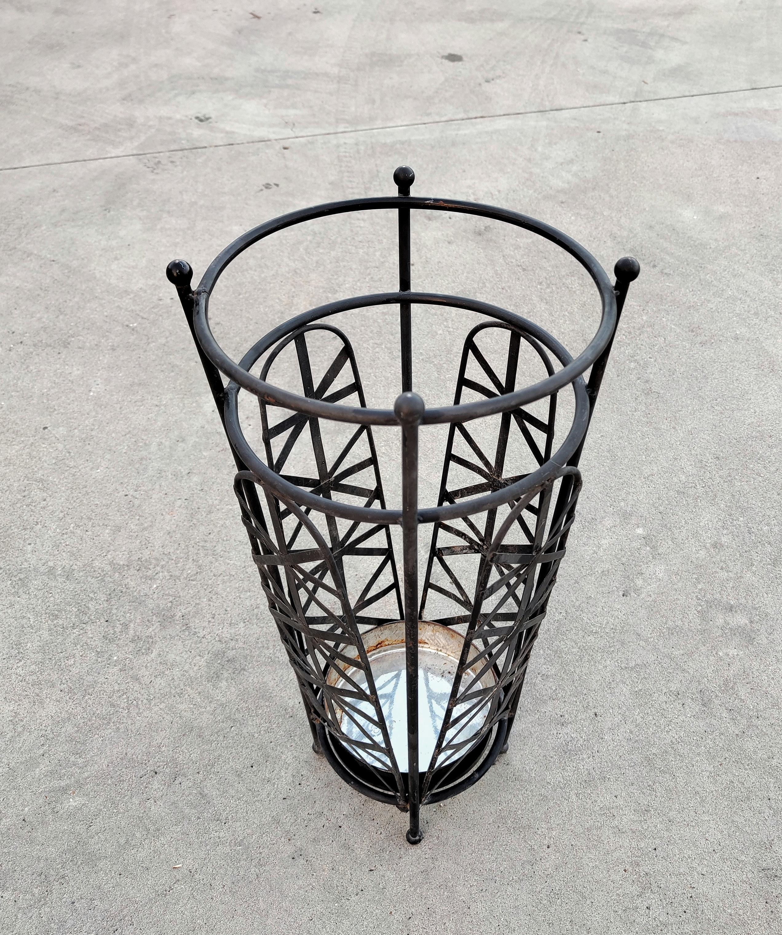 In this listing you will find a late Art Deco umbrella stand done in black iron. It features beautiful decorative woven pattern all around that gives it very elegant looks. The umbrella stand was made in Italy in 1950s.

Very good vintage condition