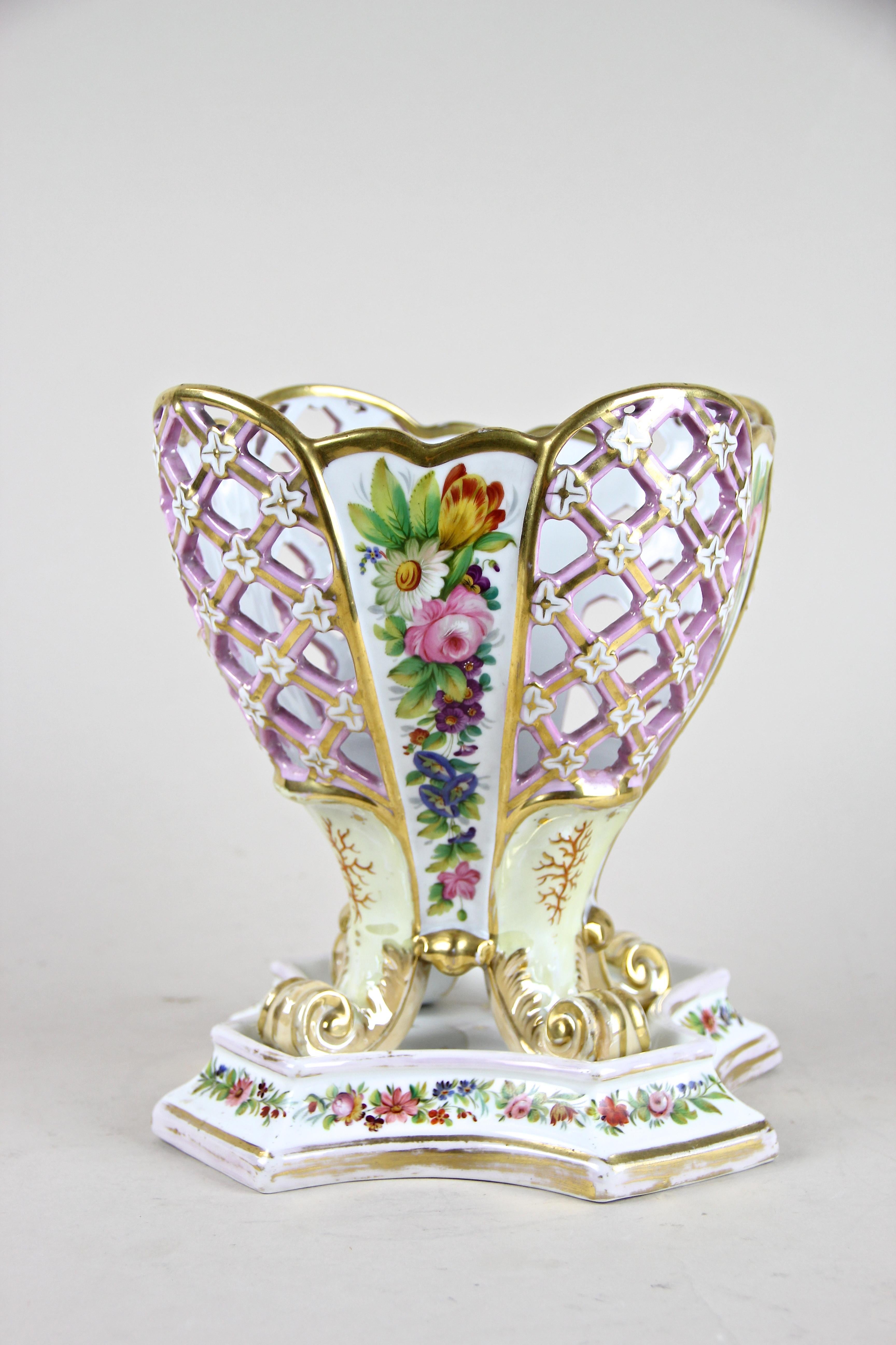 Absolute rare late bohemian Biedermeier Porcelain Basket by Fischer & Mieg, Pirkenhammer from circa 1860. By showing partly openwork sides, this decorative masterpiece stands on volute feet and impresses with a polychrome painted floral décor,