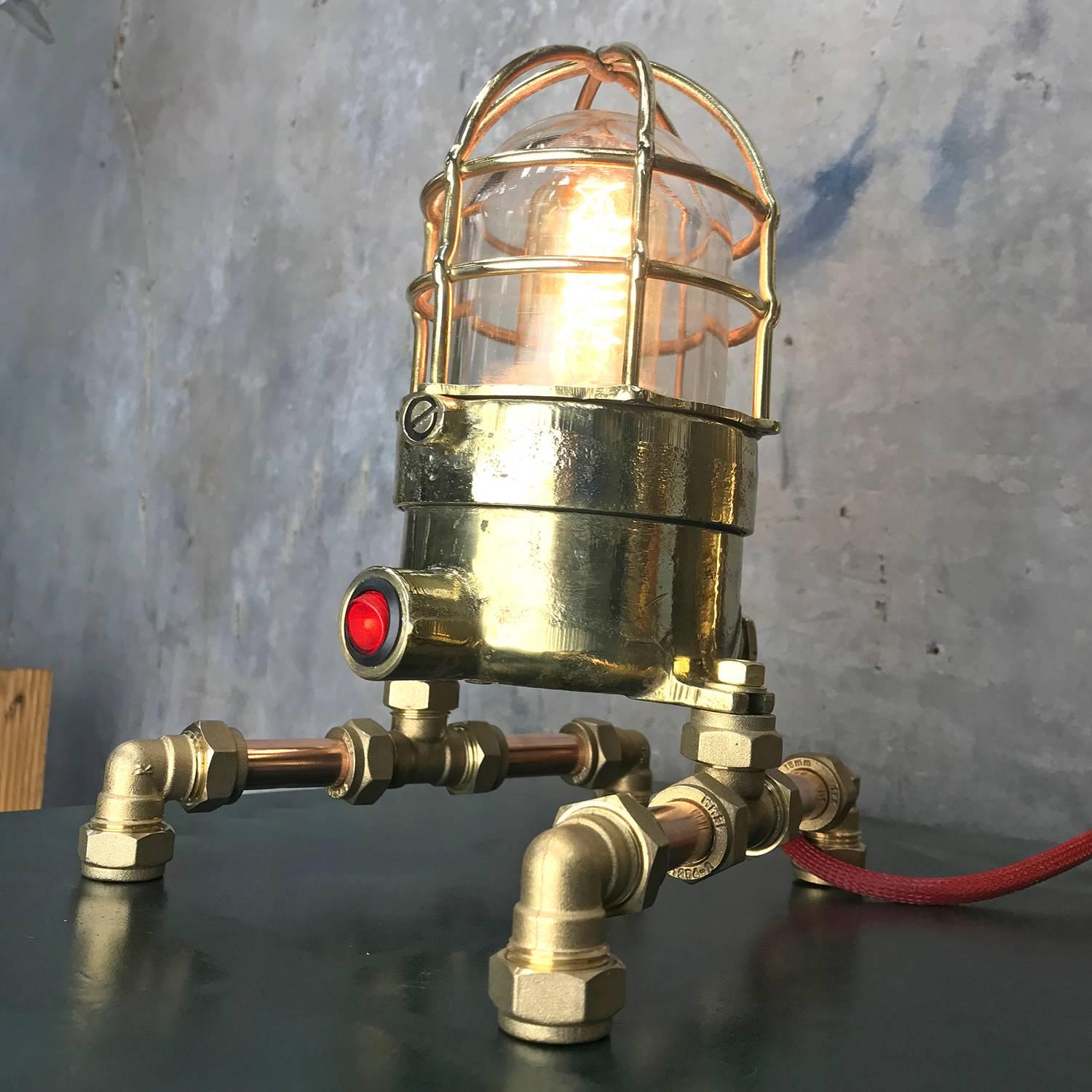 1970s Explosion proof passage way light reclaimed from a super tanker modified to function as a table or desk lamp.

The light itself is made from bronze, brass and has a tempered glass dome and protective cage.

These lights were manufactured