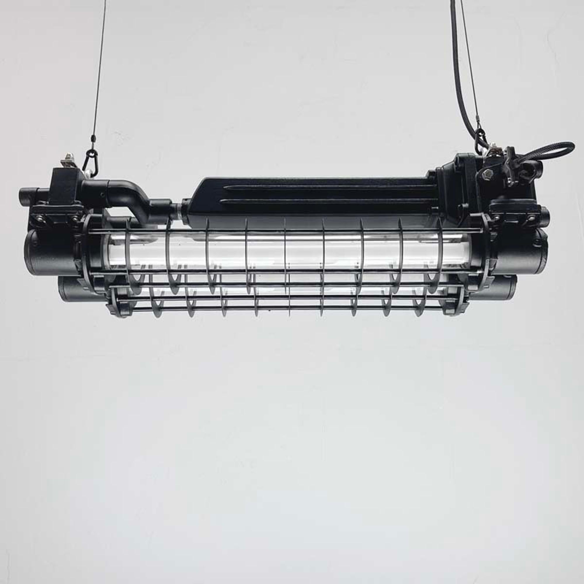 East Asian Late Century Industrial Flameproof Tube Light with Cage - Black & Brass finish For Sale