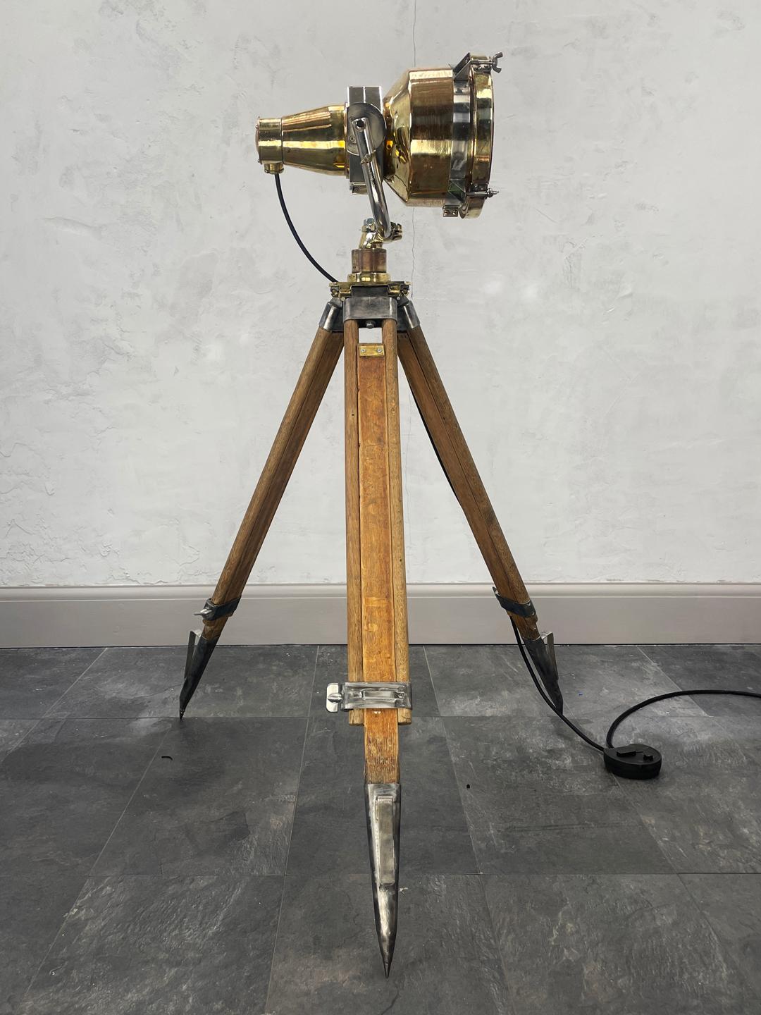 A stunning vintage Japanese brass Search lamp paired with a wooden British antique surveyors tripod, to create a completely unique floor lamp. There is limited availability of this item. 

A reclaimed and professionally restored item ready for