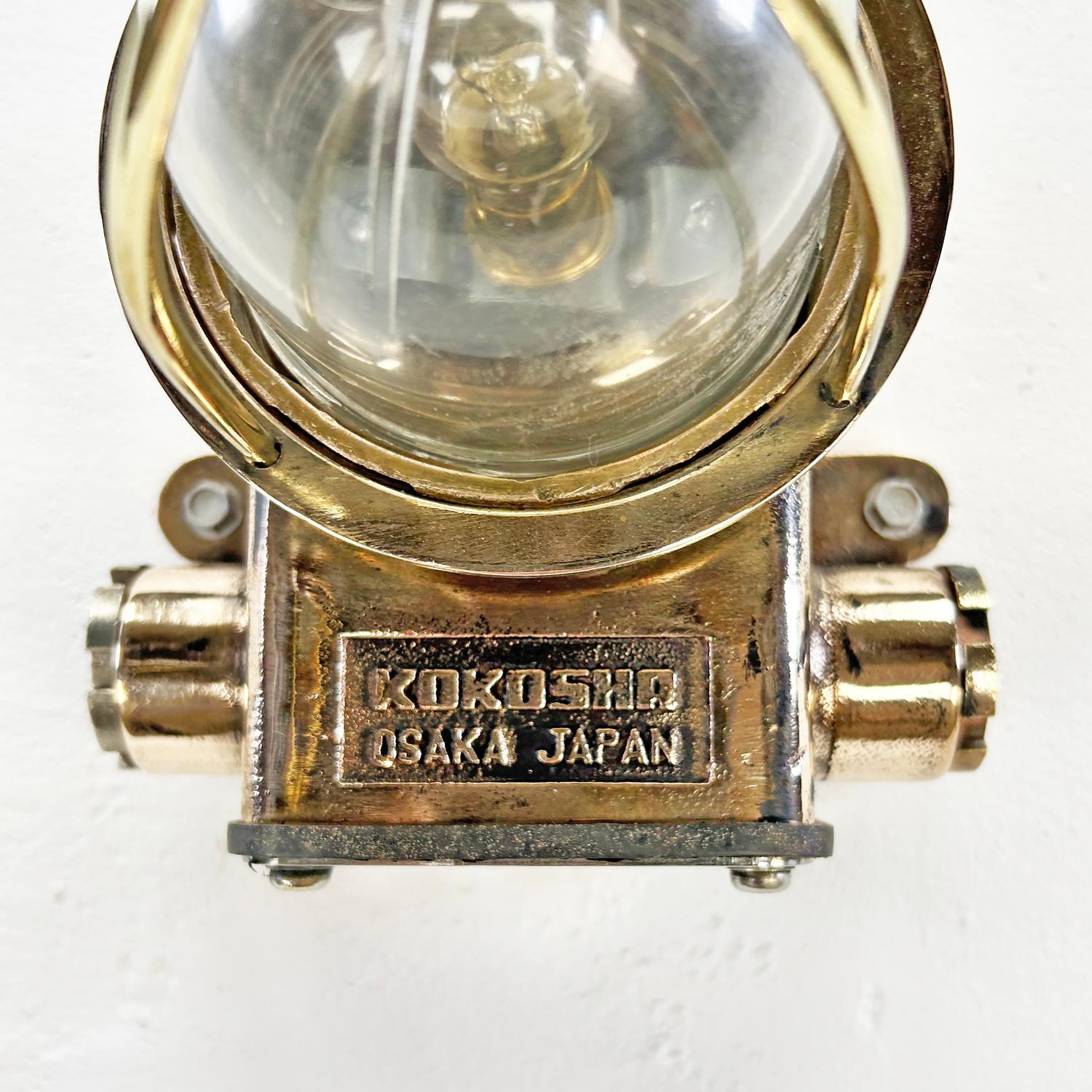 An original solid bronze passageway light by Kokosha of Osaka, Japan.

Made from solid cast bronze with a wire cage and shatter proof acrylic protective dome, this is an extremely robust fixture which was originally used on cargo ships and