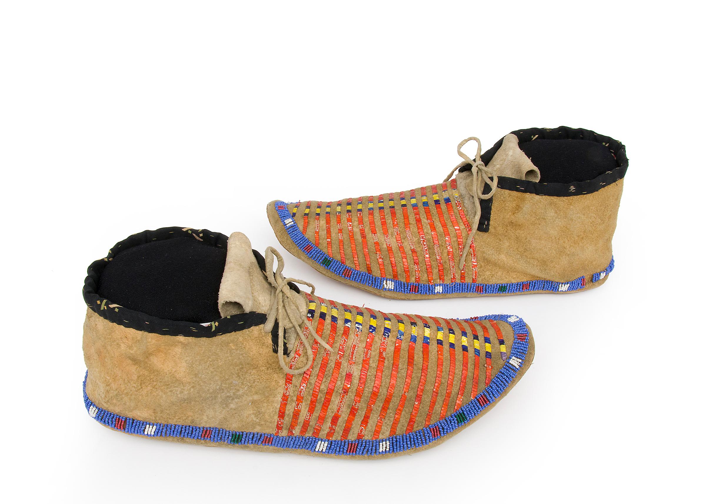 Pair of antique Native American moccasins dating to the late Classic Period (1650-1875). Hand crafted by a Sioux, Plains Indian, artisan, circa 1870s.  The moccasins are constructed of native tanned buckskin (deer hide) with bands of quill work; the