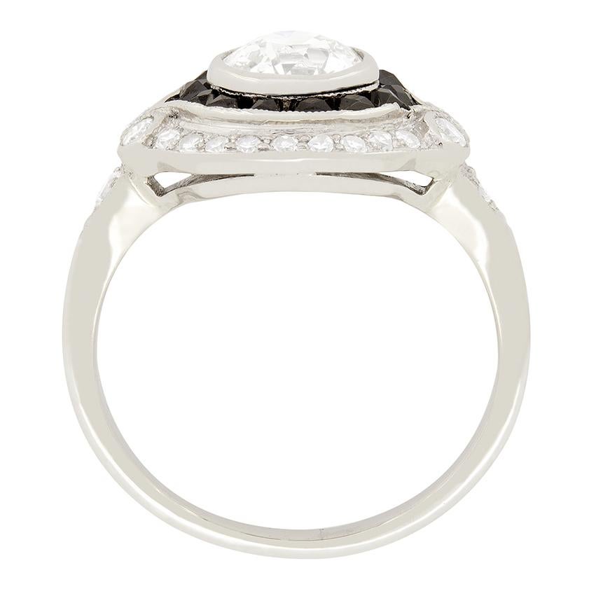 Aus den 1940er Jahren stammt dieser exquisite Platin- und Diamantring mit einem Heiligenschein aus schwarzen Onyxen im französischen Schliff von insgesamt 0,24 Karat. Der schwarze Onyx wird von einem wunderschönen Diamanten von 1,01 Karat im alten