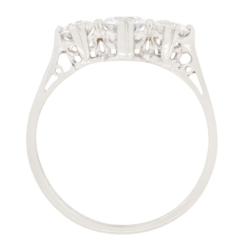 This classic Late Deco three stone ring beautifully showcases a trio of transitional cut diamonds. The central diamonds is the largest, at 0.40 carat with the flanking pair weighing 0.35 carat a piece. All three diamonds range match in quality, with