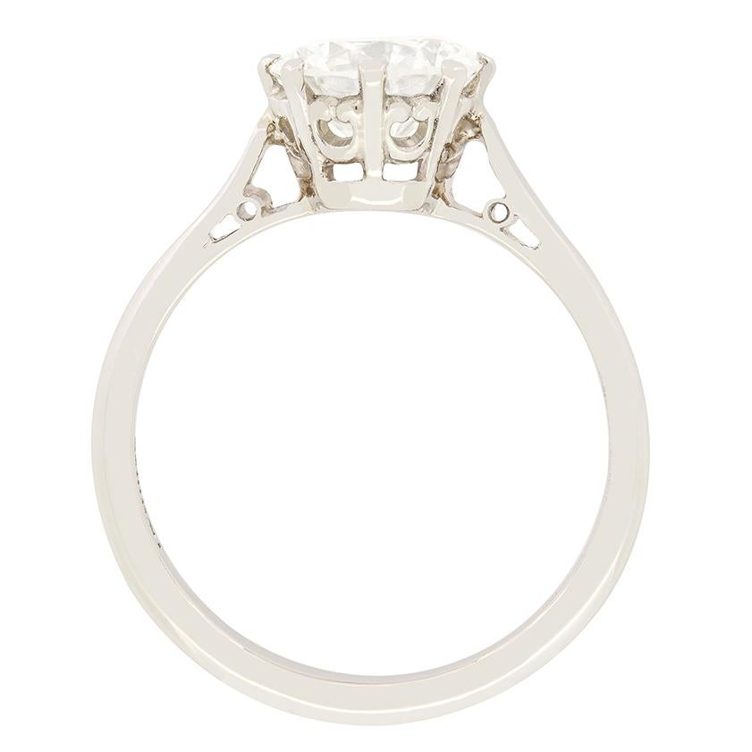 A timeless classic, this Late Deco solitaire engagement ring features a 1.65 carat diamond as its centre piece. The round brilliant stone has a colour of I and clarity of SI1, and is claw set into a decorative collet. Crafted entirely from platinum