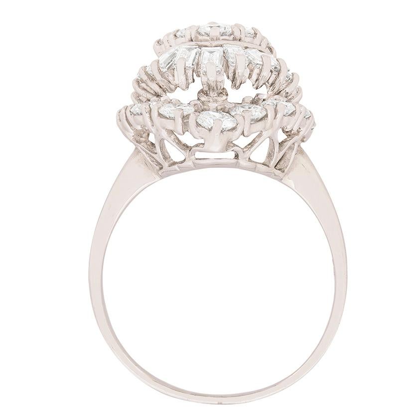 A sparkling array of round brilliants and baguette cut diamonds make up this stunning cocktail ring. The round brilliants have a combined weight of 3.10 carat and the remainder are baguette cuts, totalling 0.55 carat. All match in quality, estimated